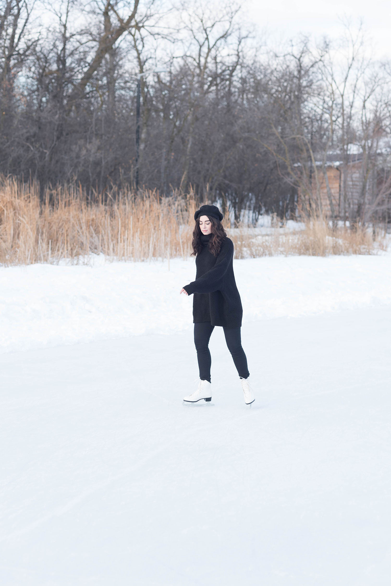 Fashion blogger Cee Fardoe of Coco & Vera ice skating at Assiniboine Park in Winnipeg wearing Mavi jeans and a Zara sweater