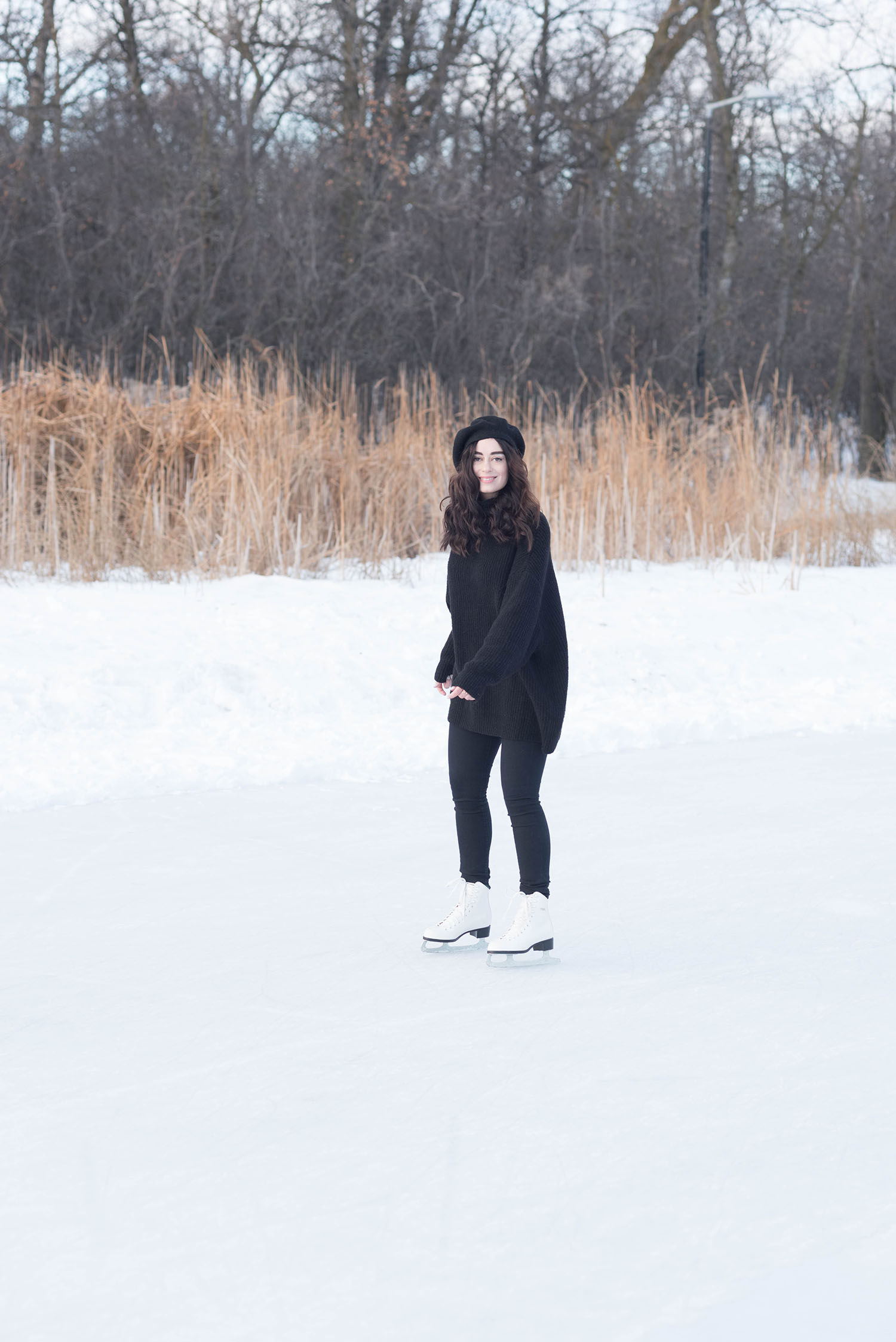 Fashion blogger Cee Fardoe of Coco & Vera skates at Assiniboine Park in Winnipeg wearing an oversized Zara sweater and Anthropologie Bonnie beret