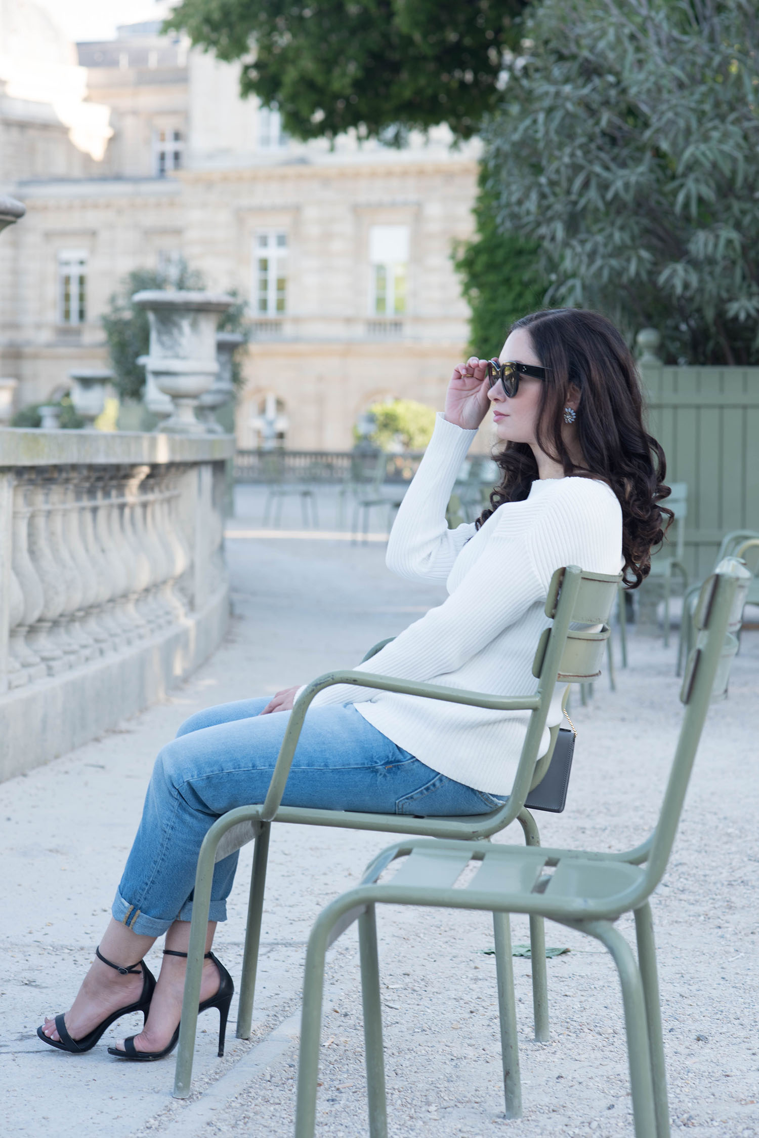 Winnipeg fashion blogger Cee Fardoe of Coco & Vera sits in the Jardin du Luxembourg in Paris wearing Zara boyfriend jeans and Steve Madden Stecy sandals