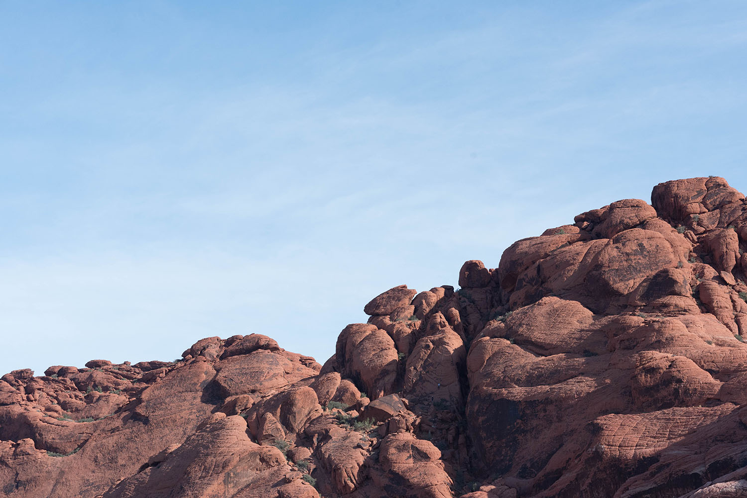 Red boulders against a blue sky at Red Rock Canyon in Nevada, as photographed by Canadian travel blogger Cee Fardoe of Coco & Vera