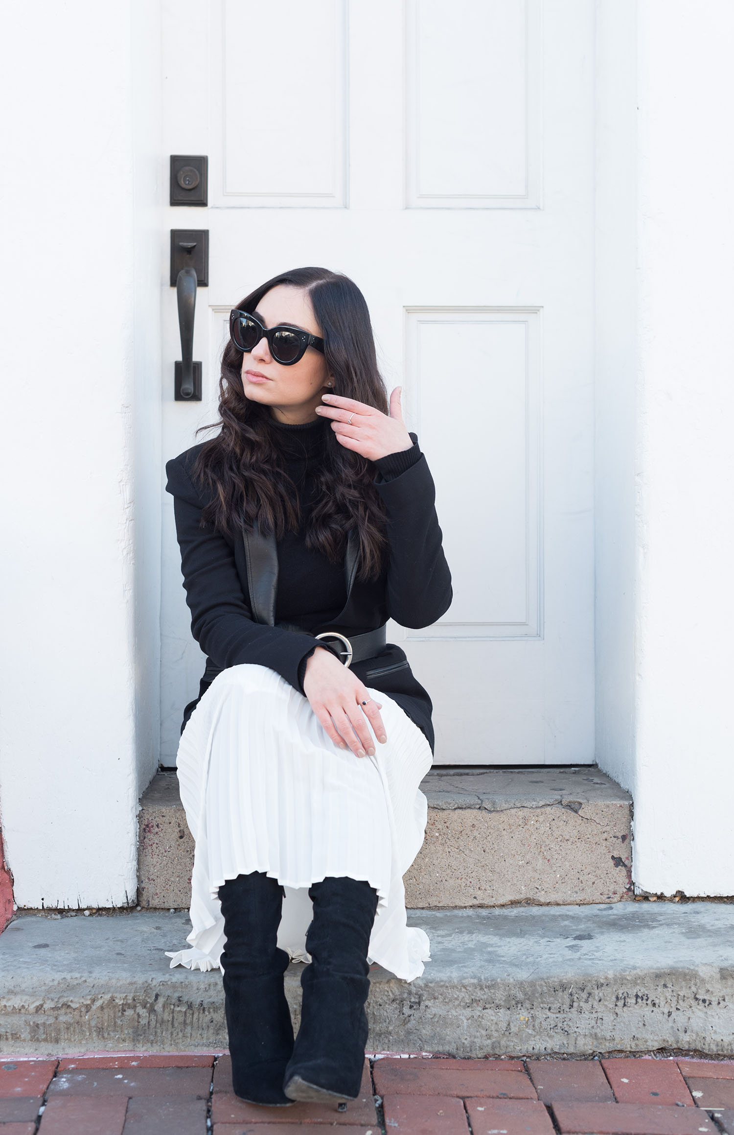 Fashion blogger Cee Fardoe of Coco & Vera sits on a doorstop in Georgetown, wearing a Helmut Lang blazer and Aldo over the knee boots
