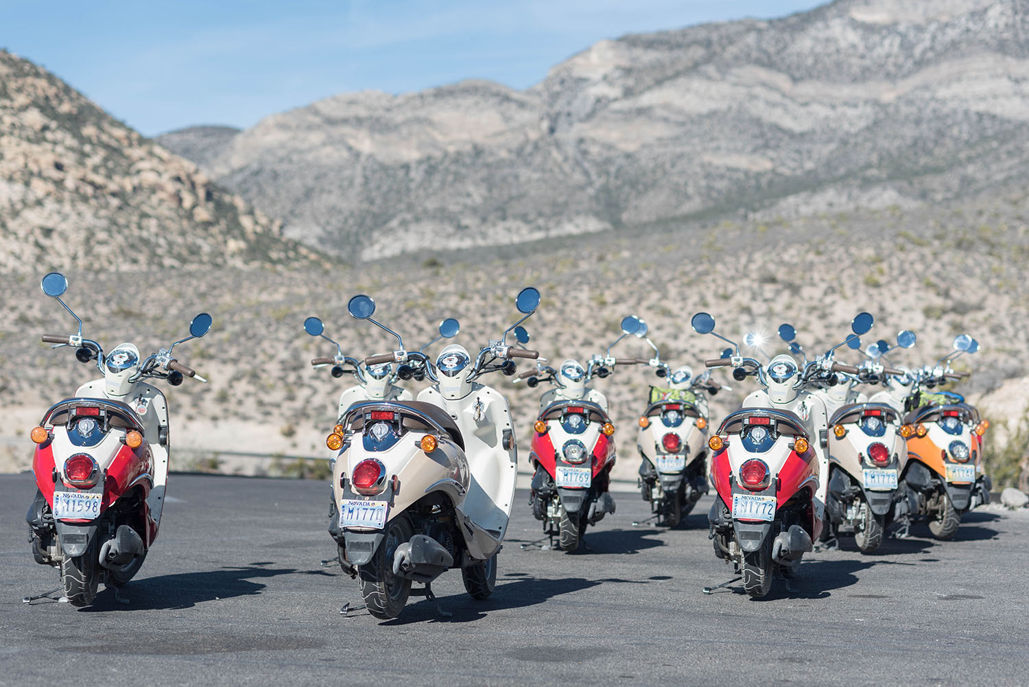 A group of parked scooters lined up against a mountain backdrop at Red Rock Canyon, as captured by travel blogger Cee Fardoe of Coco & Vera