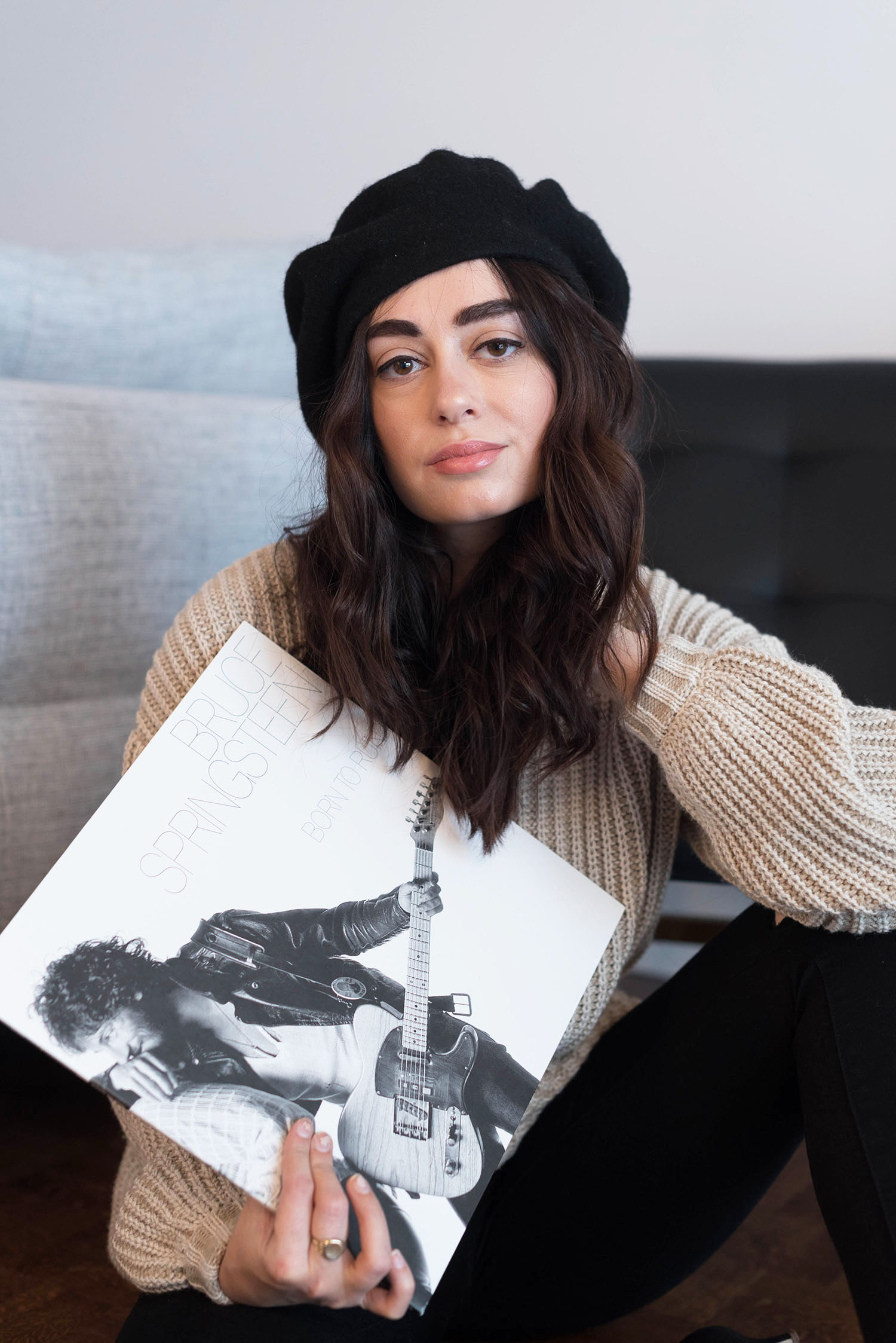 Portrait of Canadian fashion blogger Cee Fardoe of Coco & Vera holding a Bruce Springsteen Born to Run record, wearing a Shop Tobi sweater and Anthropologie beret