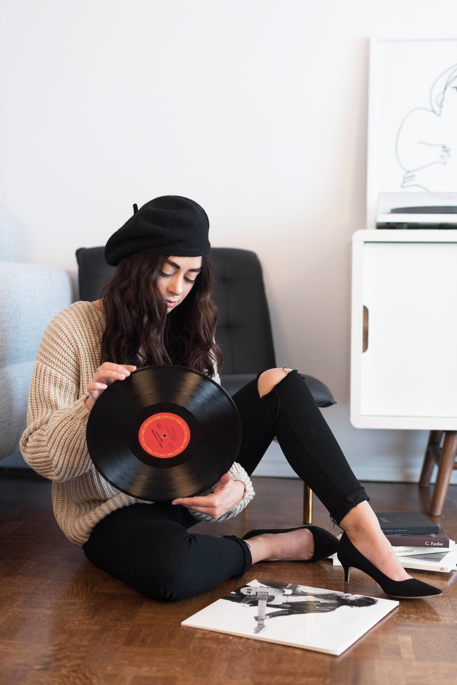 Winnipeg fashion blogger Cee Fardoe of Coco & Vera holds a Bruce Springsteen record wearing J. Crew kitten heels and black Paige jeans