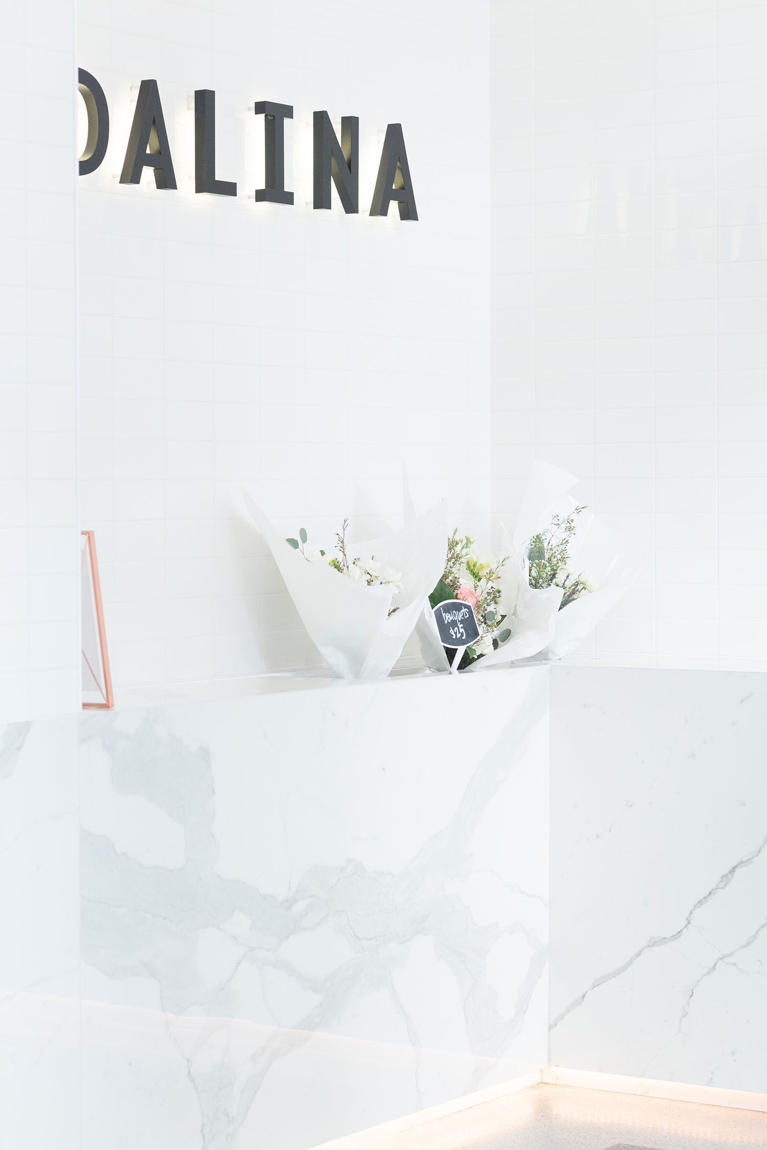 The white and marble interior of Vancouver coffee shop Dalina, as captured by top Canadian travel blogger Cee Fardoe of Coco & Vera