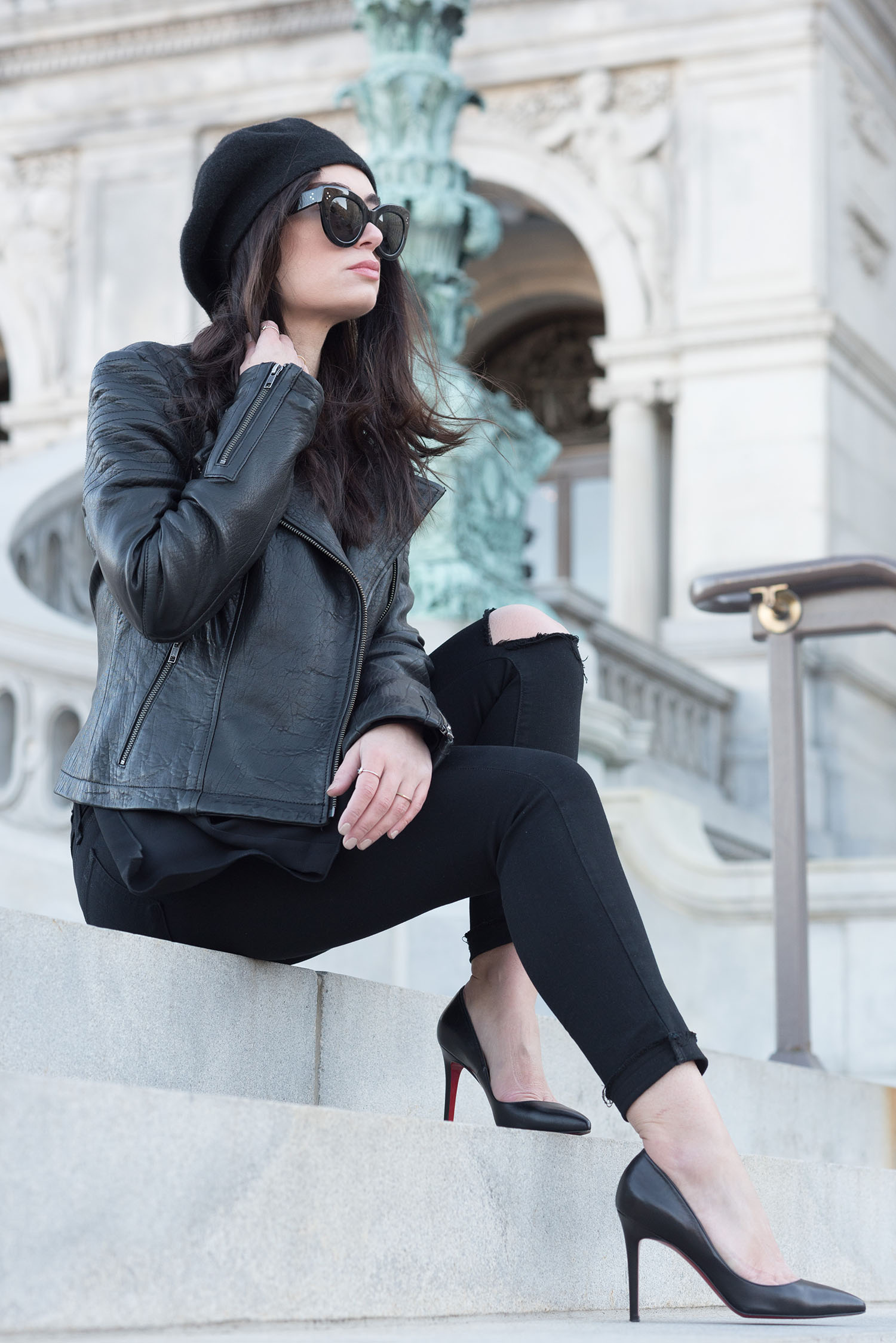 Fashion blogger Cee Fardoe of Coco & Vera sits outside the Library of Congress wearing Celine Audrey sunglasses and an Anthropologie Bonnie beret