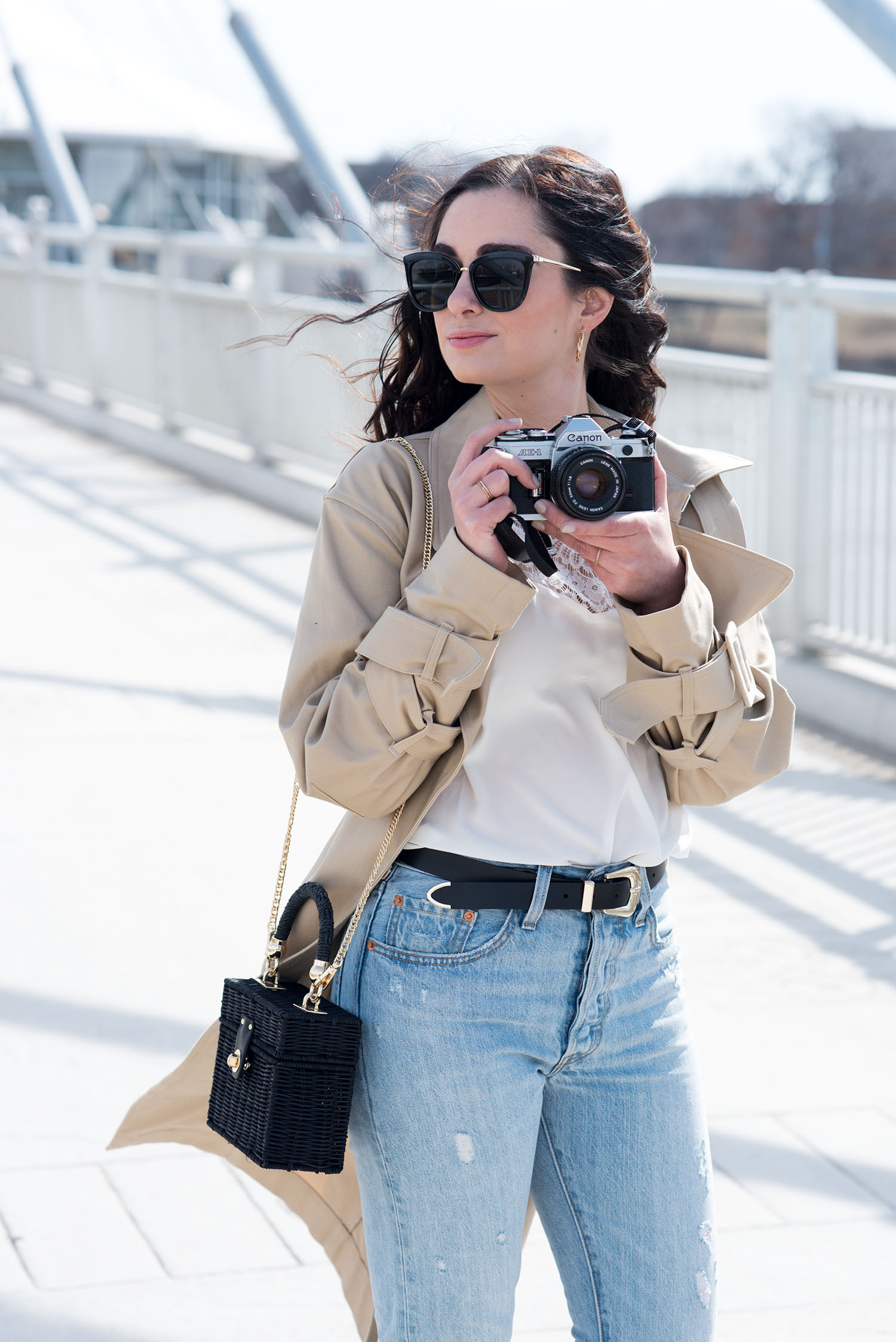 Portrait of Canadian fashion blogger Cee Fardoe of Coco & Vera wearing Le Specs sunglasses and holding a vintage Canon camera