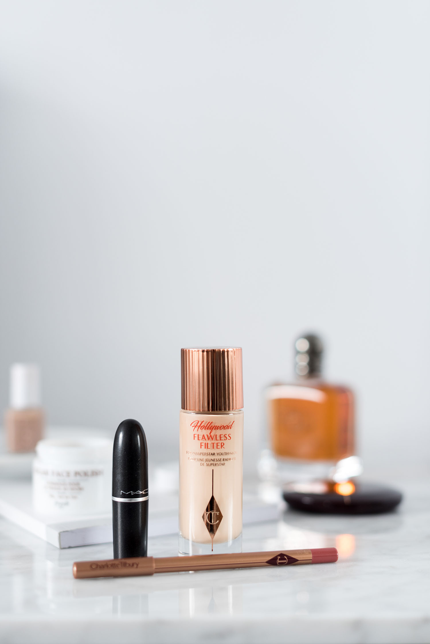 Charlotte Tilbury Hollywood Flawless Filter sits next to a MAC lipstick, as captured by top beauty blogger Cee Fardoe of Coco & Vera