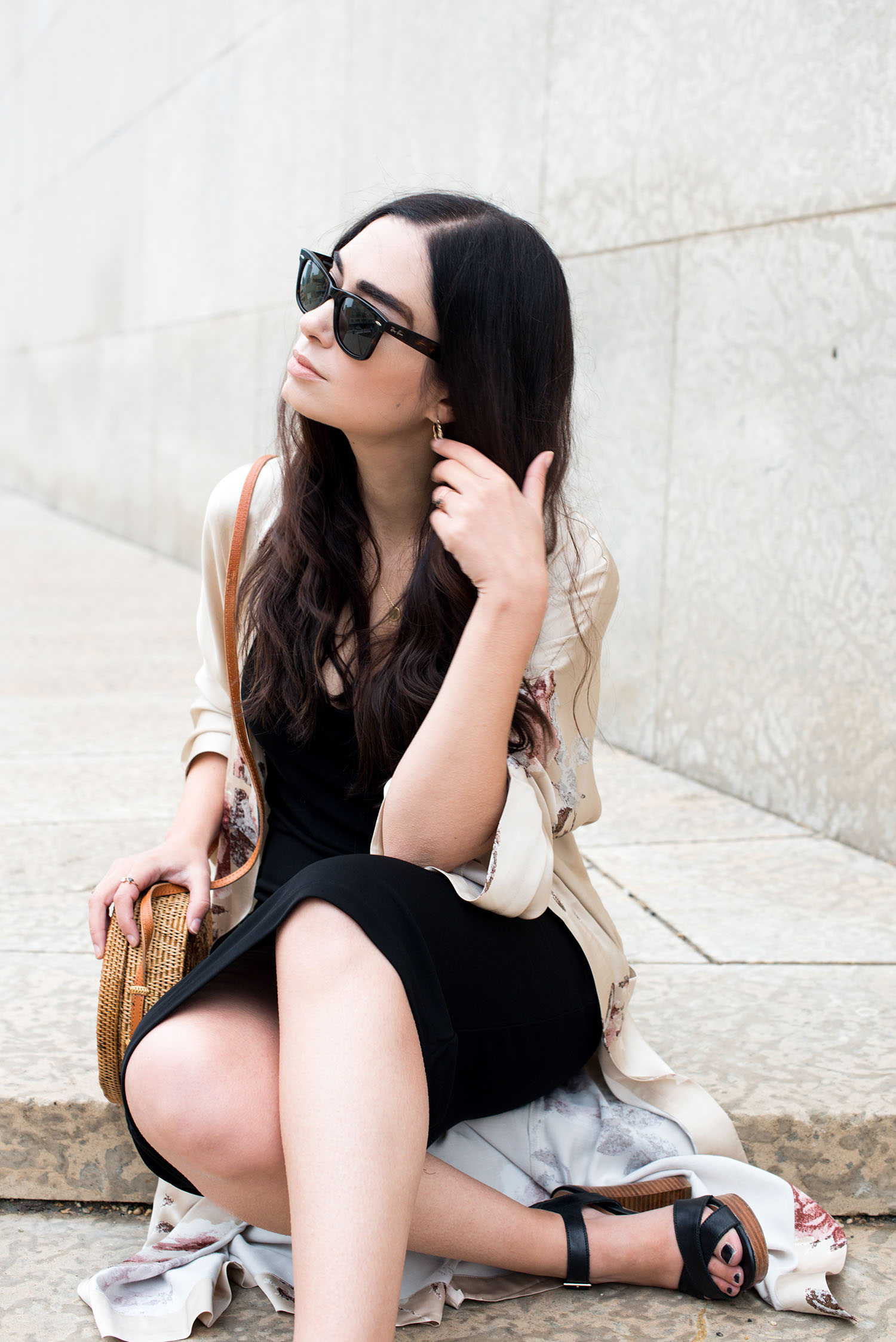 Top Canadian fashion blogger Cee Fardoe of Coco & Vera sits on the steps of the Winnipeg Art Gallery wearing an & Other Stories dress and RayBan sunglasses