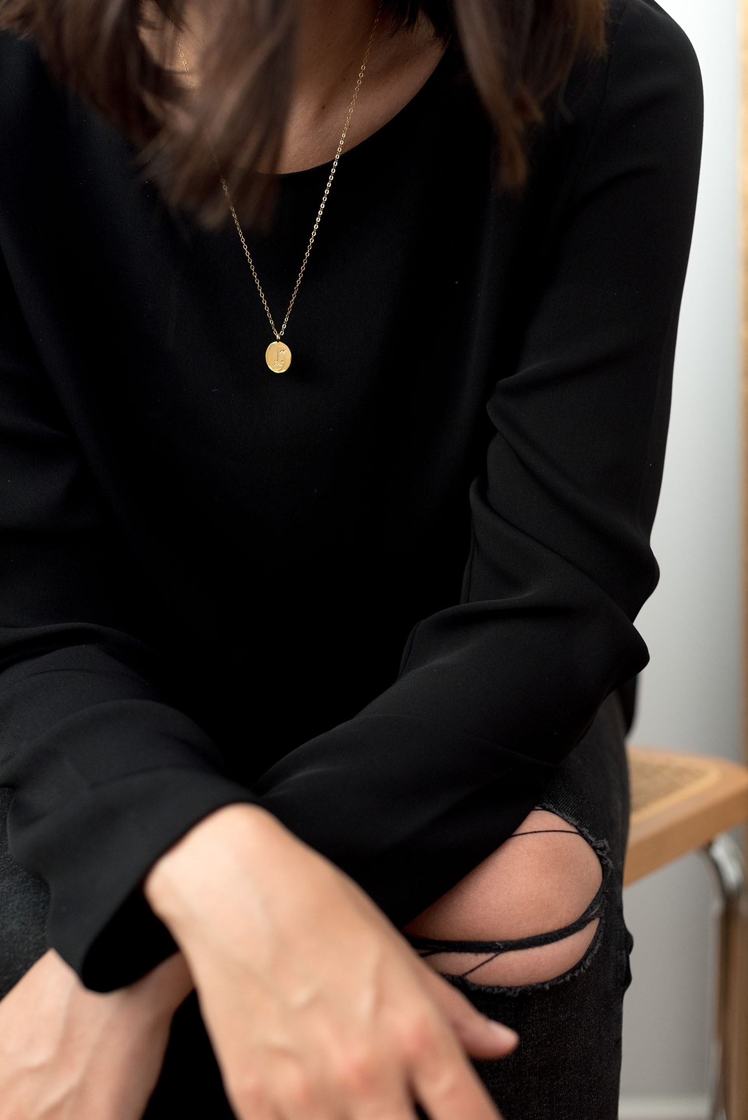 Outfit details on top Winnipeg fashion blogger Cee Fardoe of Coco & Vera, including a black Aritzia Koons blouse and Wolf Circus Matisse necklace