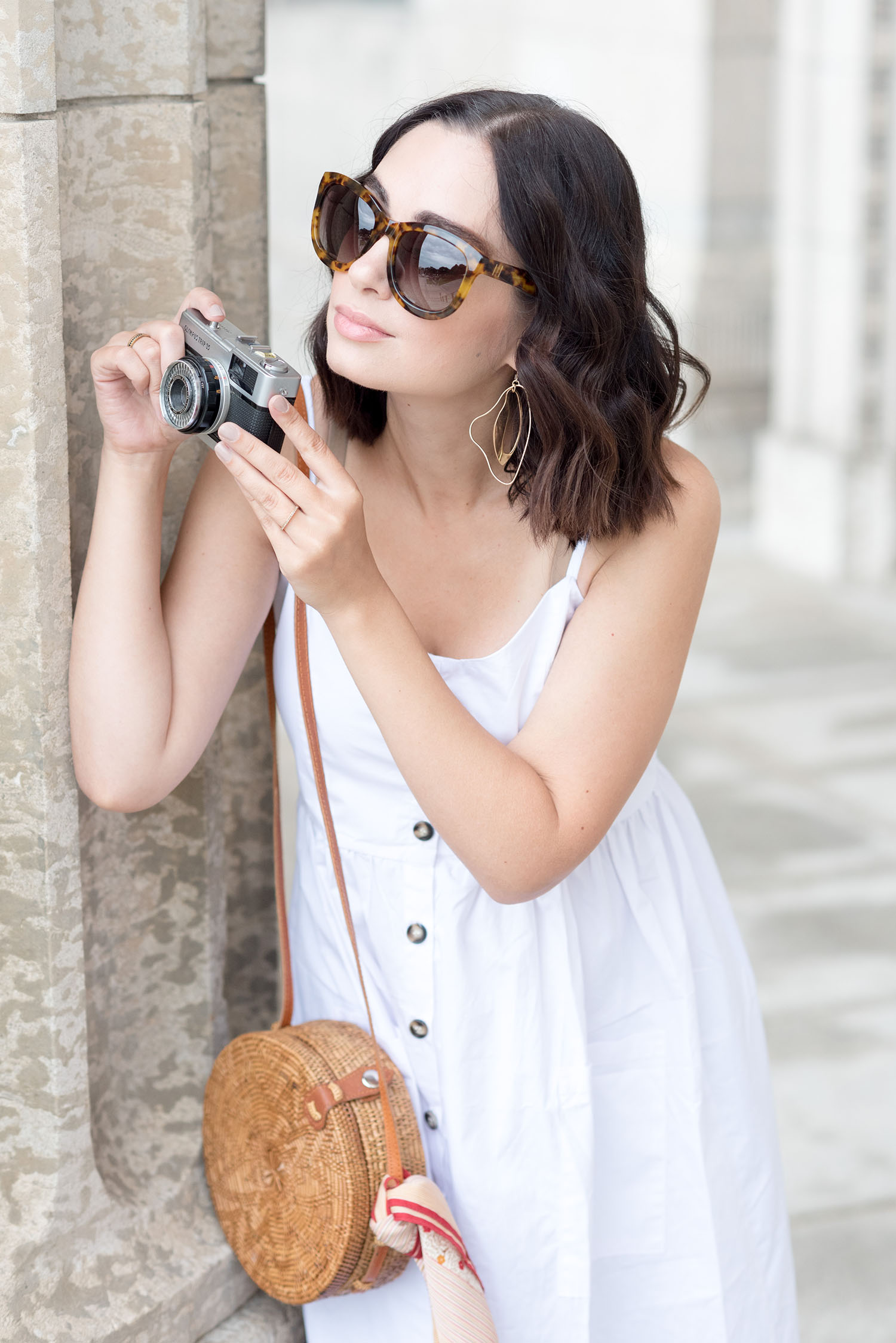 Top Canadian fashion blogger Cee Fardoe of Coco & Vera takes a picture on a vintage Olympus camera wearing Anine Bing Los Angeles sunglasses