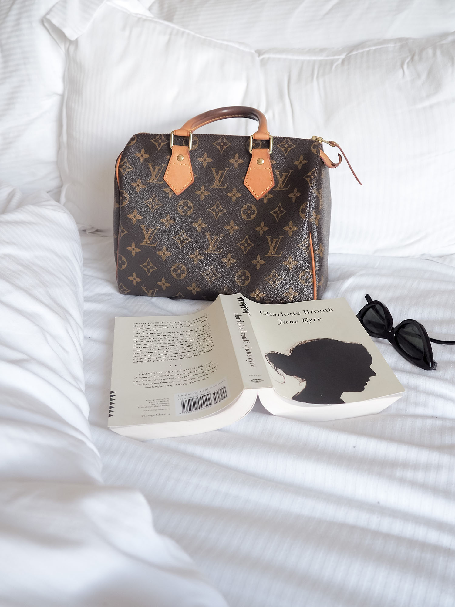 A Louis Vuitton Speedy 25 bag on the bed at The Lord Nelson Hotel in Halifax, as captured by top Winnipeg travel blogger Cee Fardoe of Coco & Vera