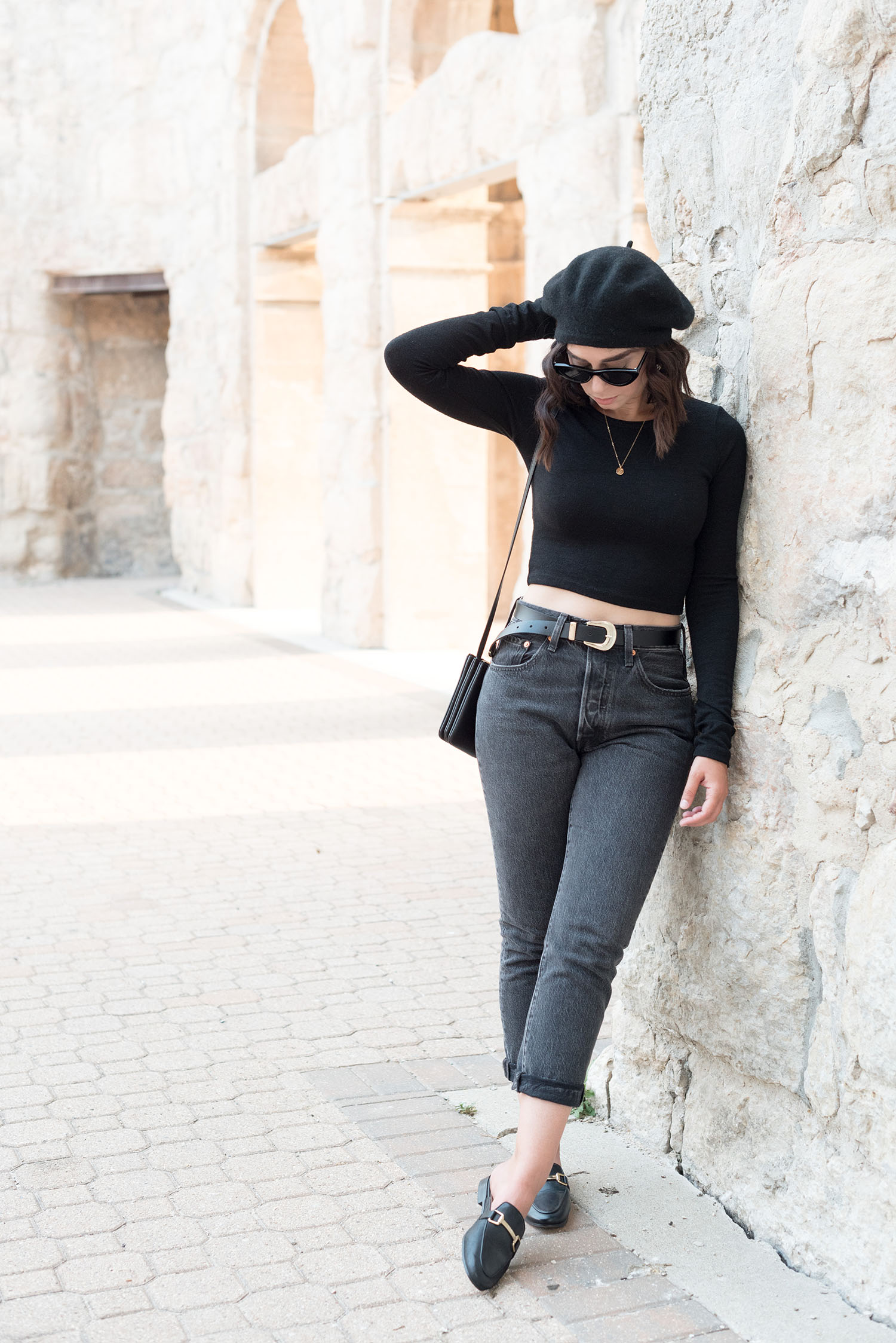 Top Winnipeg fashion blogger Cee Fardoe of Coco & Vera stands at Saint Boniface Cathedral wearing Levis' 501 jeans and Jonak mules