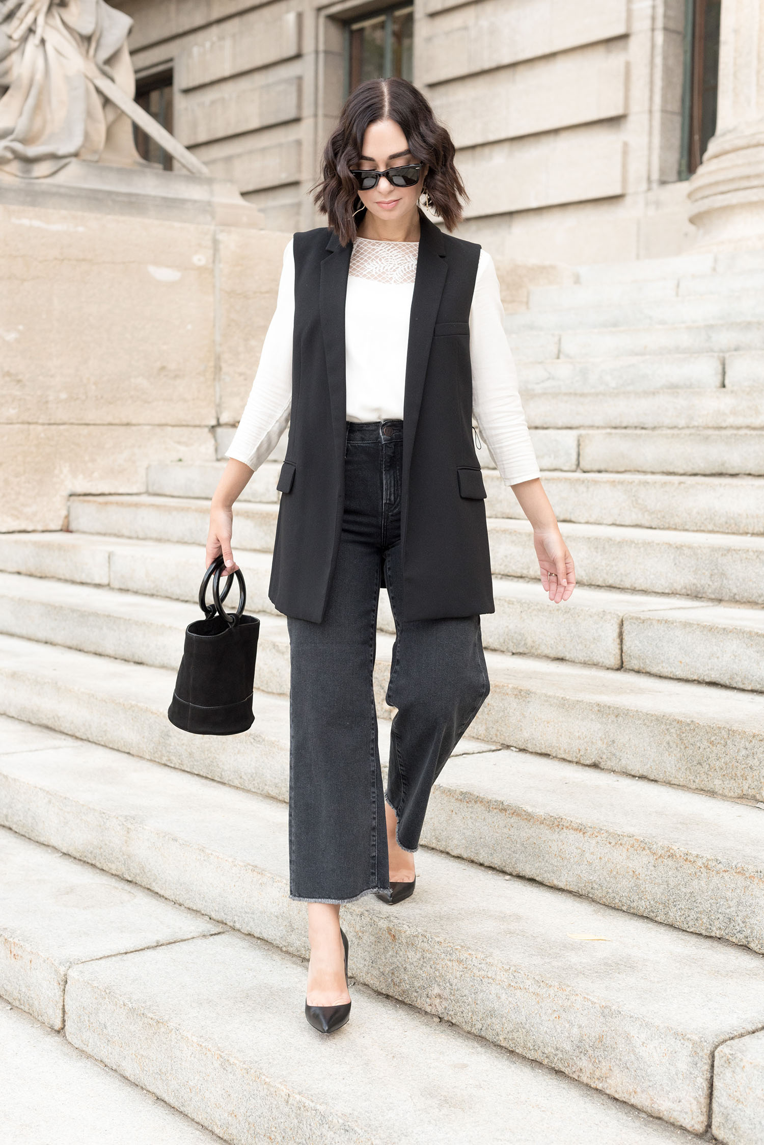 Top Winnipeg fashion blogger Cee Fardoe of Coco & Vera walks wearing Mavi jeans and a Zara vest