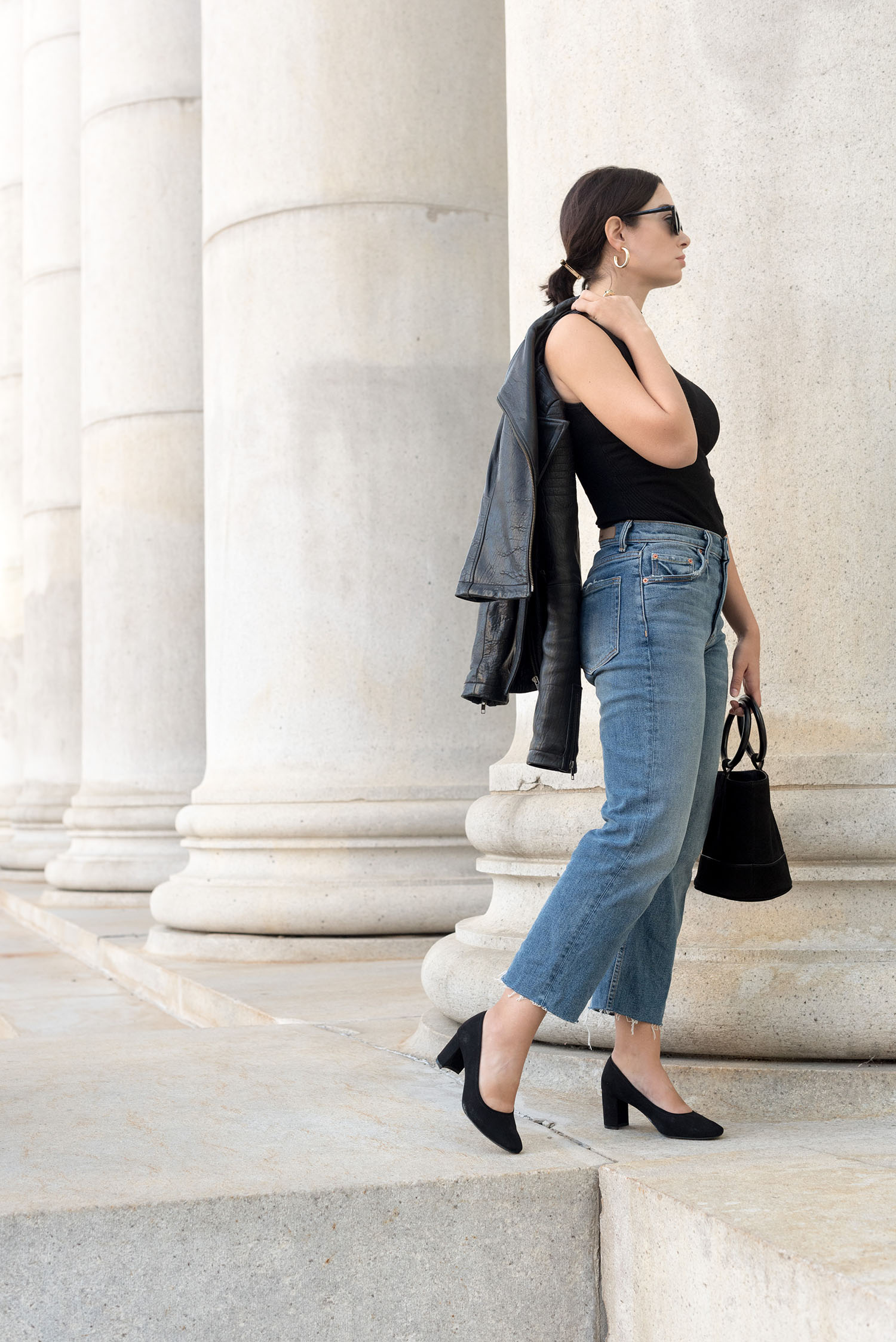 Top Winnipeg fashion blogger Cee Fardoe of Coco & Vera stands outside the Bank of Montreal wearing Grlfrnd Helena jeans and H&M block heels