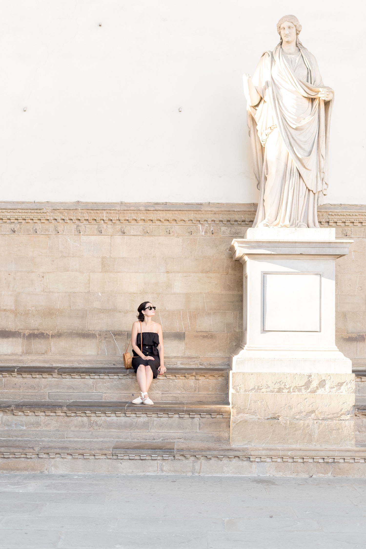 Top Canadian fashion blogger Cee Fardoe of Coco & Vera sits at the Uffizi Gallery wearing a ShopUniques dress and carrying an Ellen James handbag