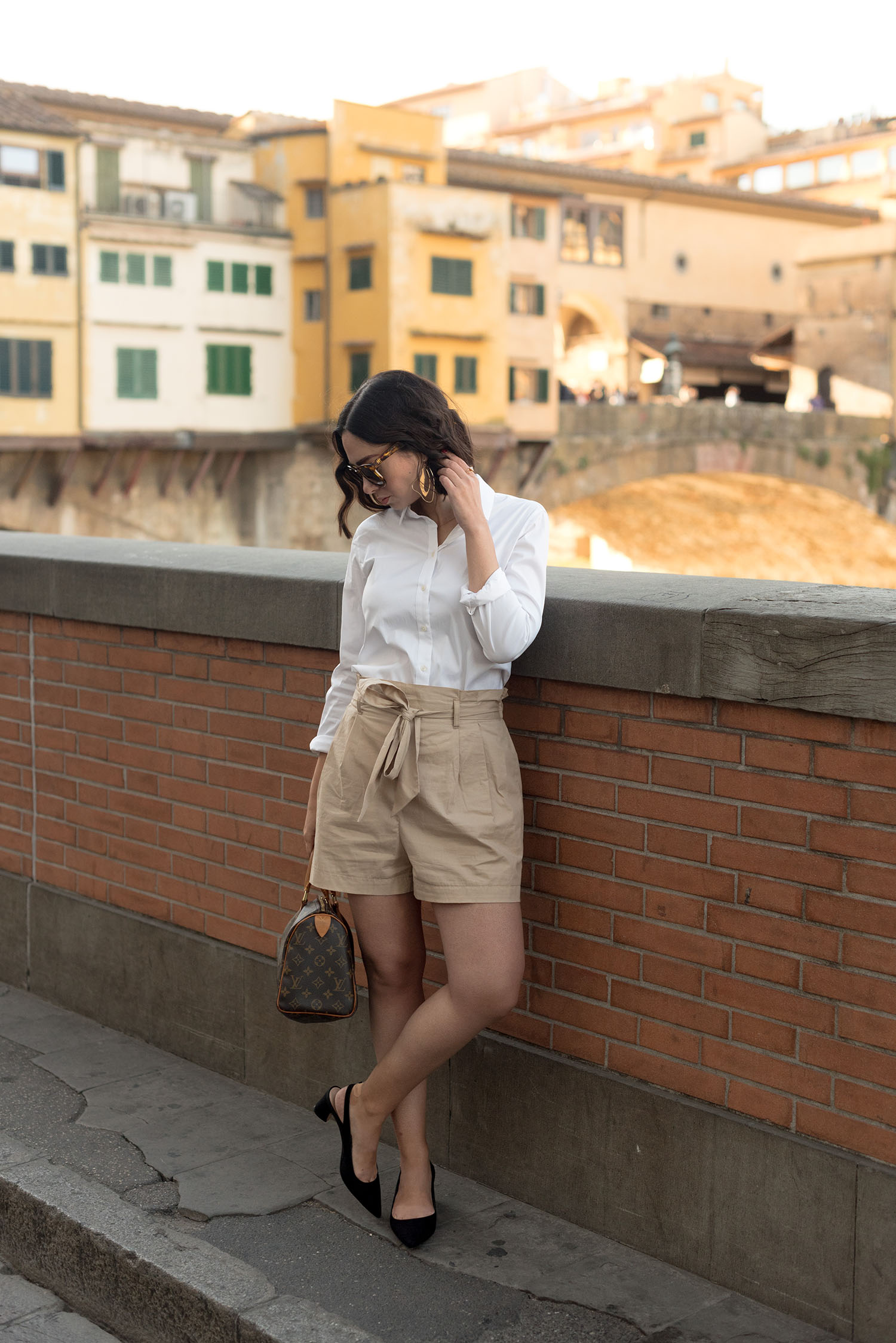 Top Winnipeg fashion blogger Cee Fardoe of Coco & Vera in Florence, Italy, wearing Zara paperboy waist shorts and a Uniqlo white oxford shirt