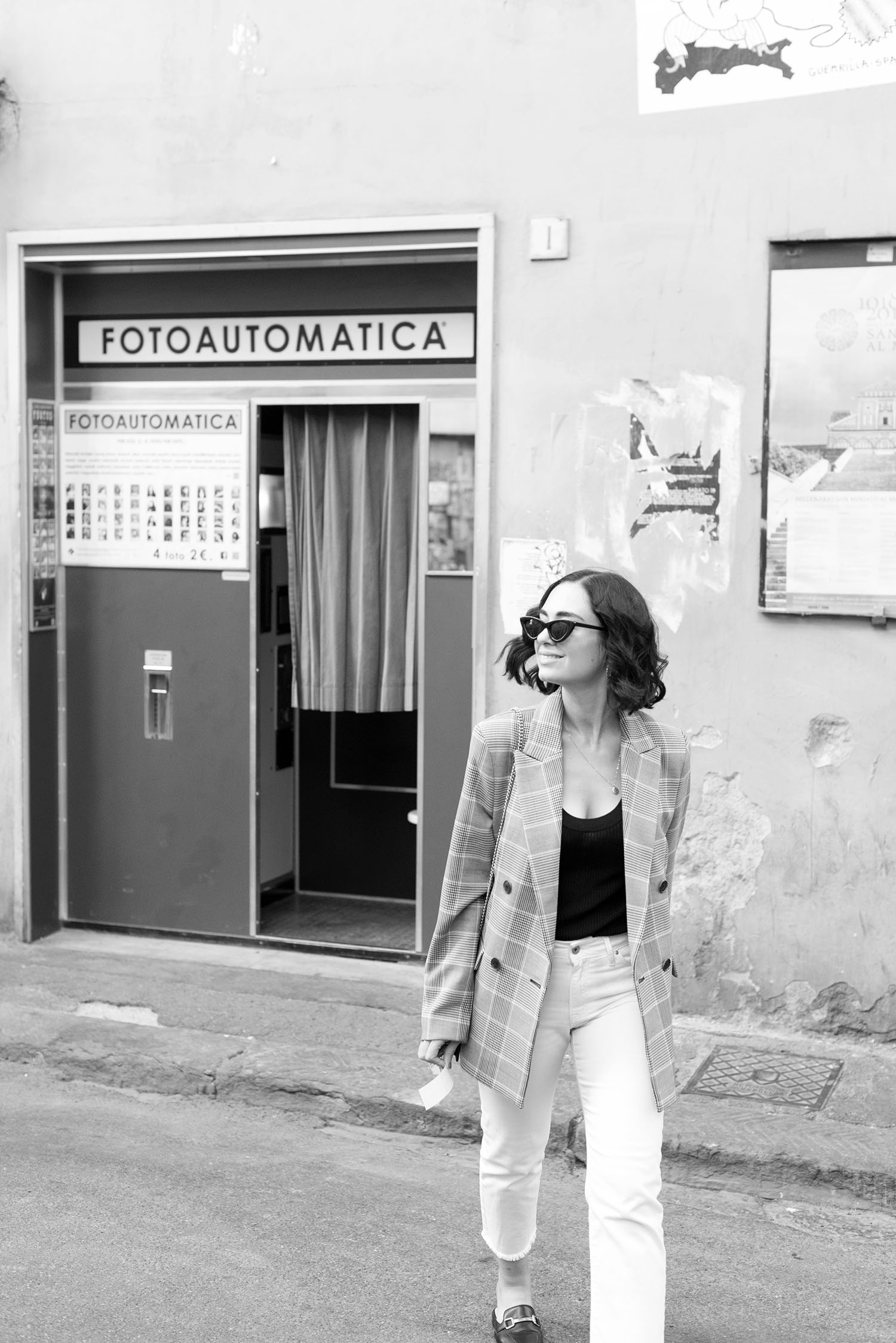 Top Canadian fashion blogger Cee Fardoe of Coco & Vera crosses the street in Florence, Italy, wearing a Mango tweed blazer and Zara ribbed top
