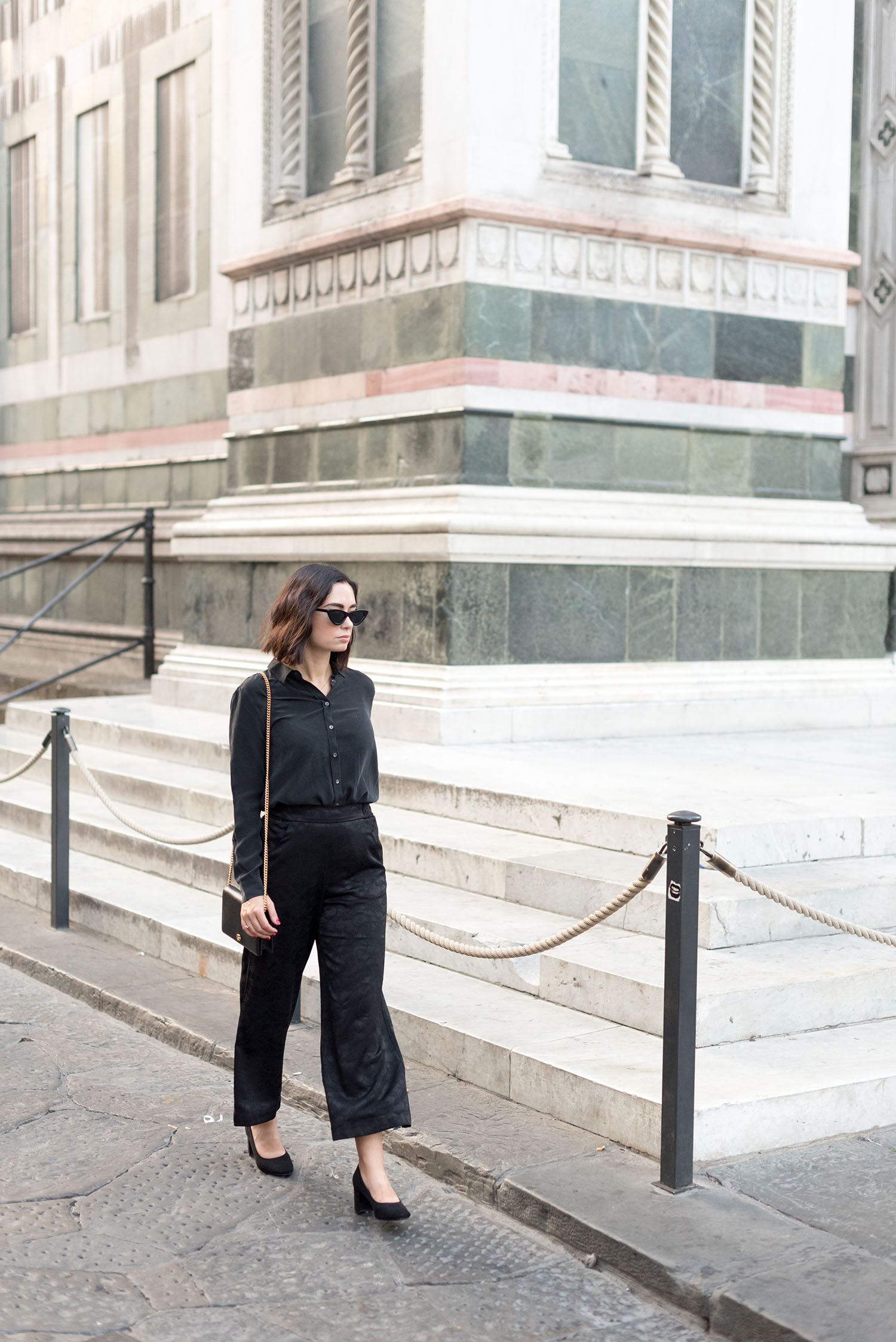Top Winnipeg fashion blogger Cee Fardoe of Coco & Vera walks outside the Duomo in Florence, wearing an Everlane blouse and H&M block heels