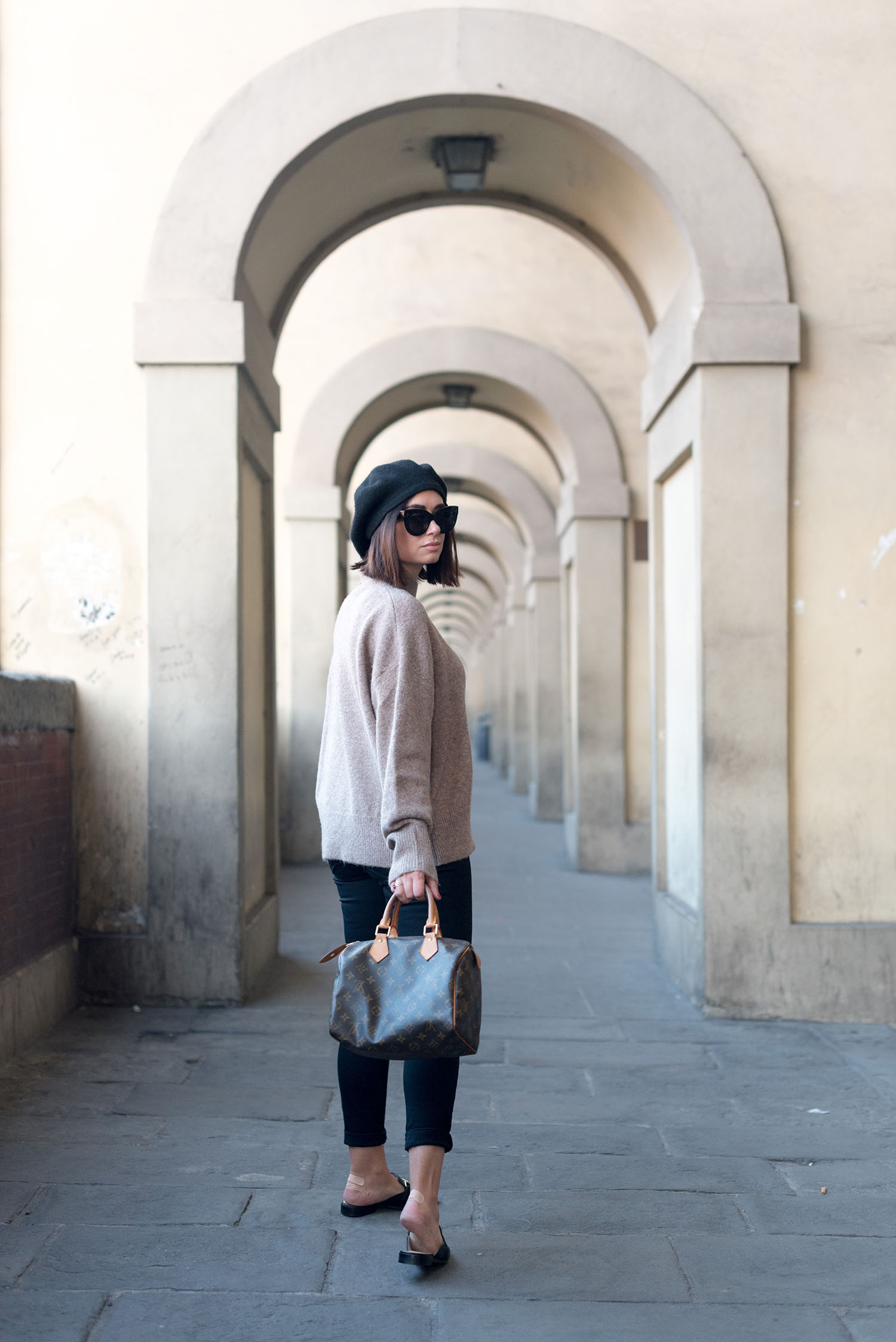 Top Winnipeg fashion blogger Cee Fardoe of Coco & Vera in Florence, Italy, wearing an H&M sweater and Jonak mules