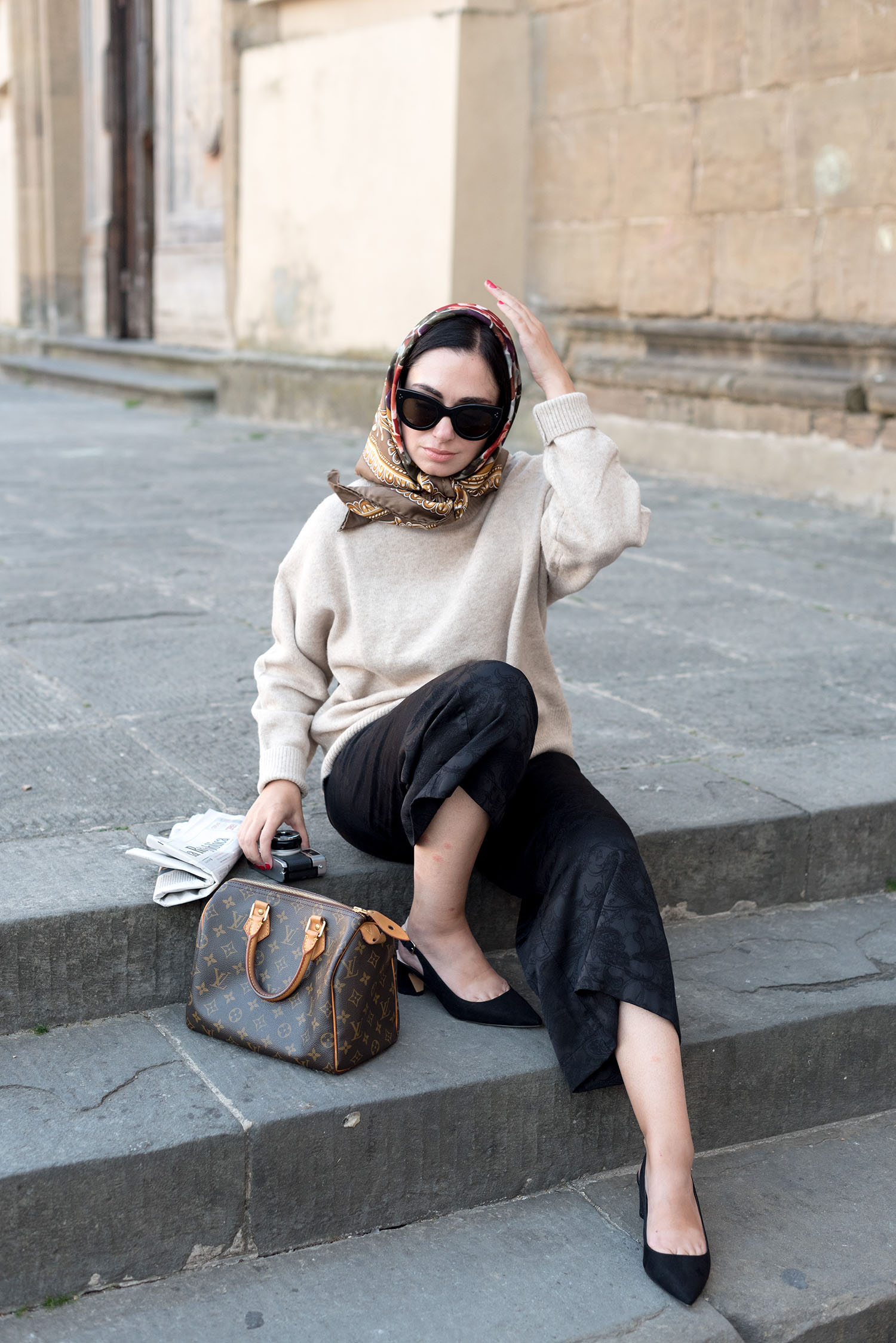 Top Winnipeg fashion blogger Cee Fardoe sits at Piazza del Carmine in Florence, wearing a vintage silk scarf and Aritzia brocade culottes