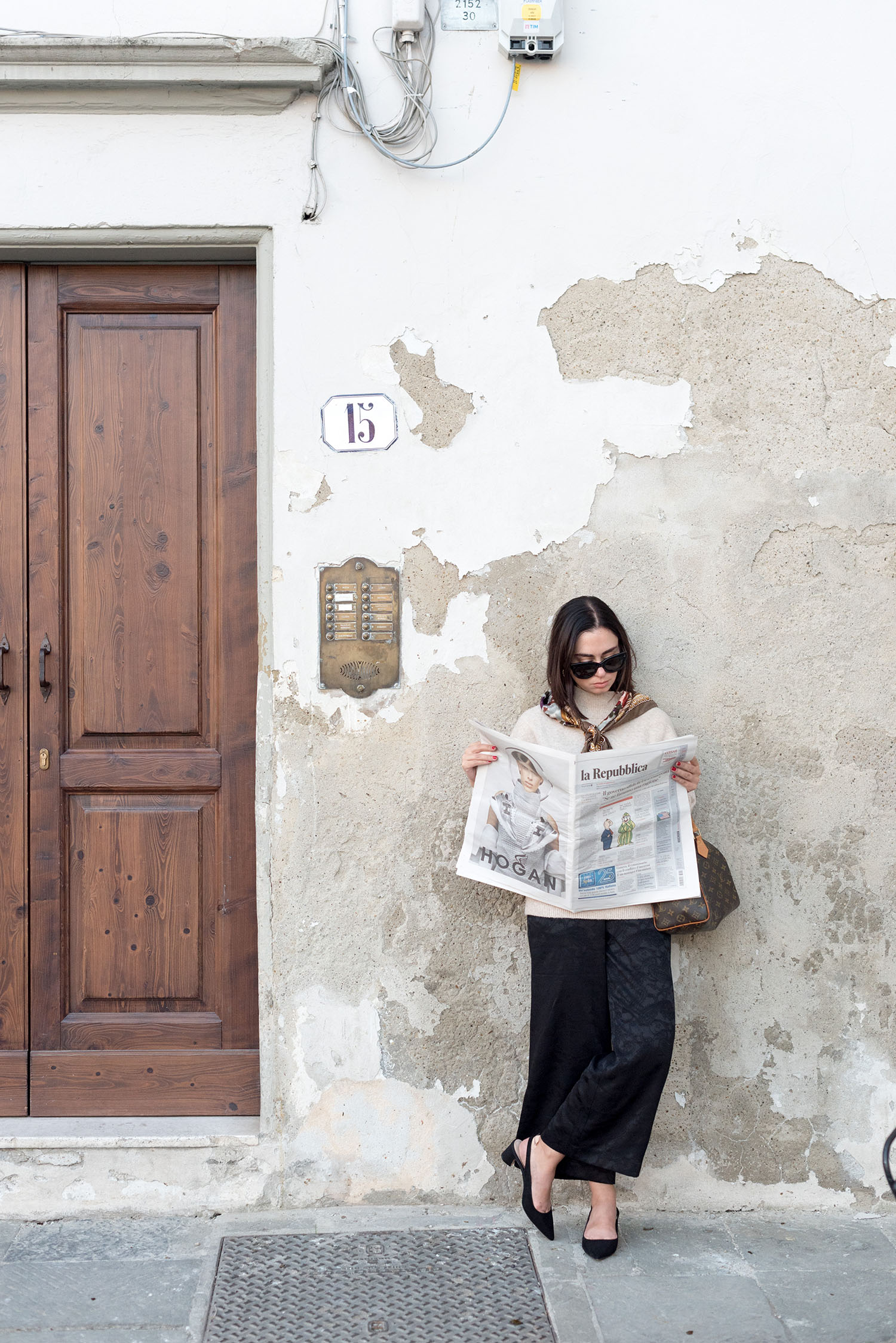 Top Winnipeg fashion blogger reads La Repubblica in Florence, Italy, wearing Mango slingback pumps and Celine Audrey sunglasses