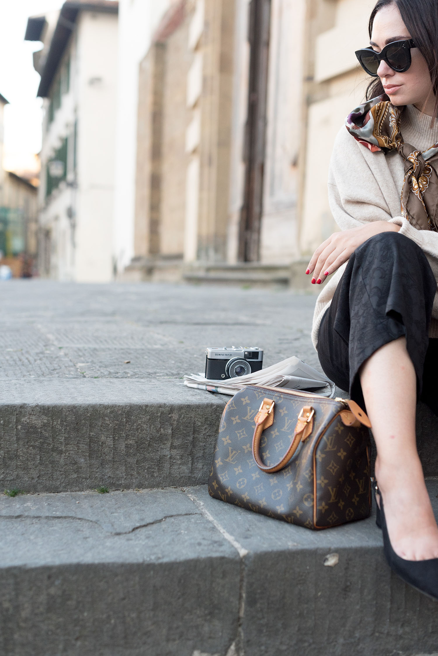 Portrait of top Canadian fashion blogger in Florence, Italy, wearing an H&M sweater and Mango slingback pumps