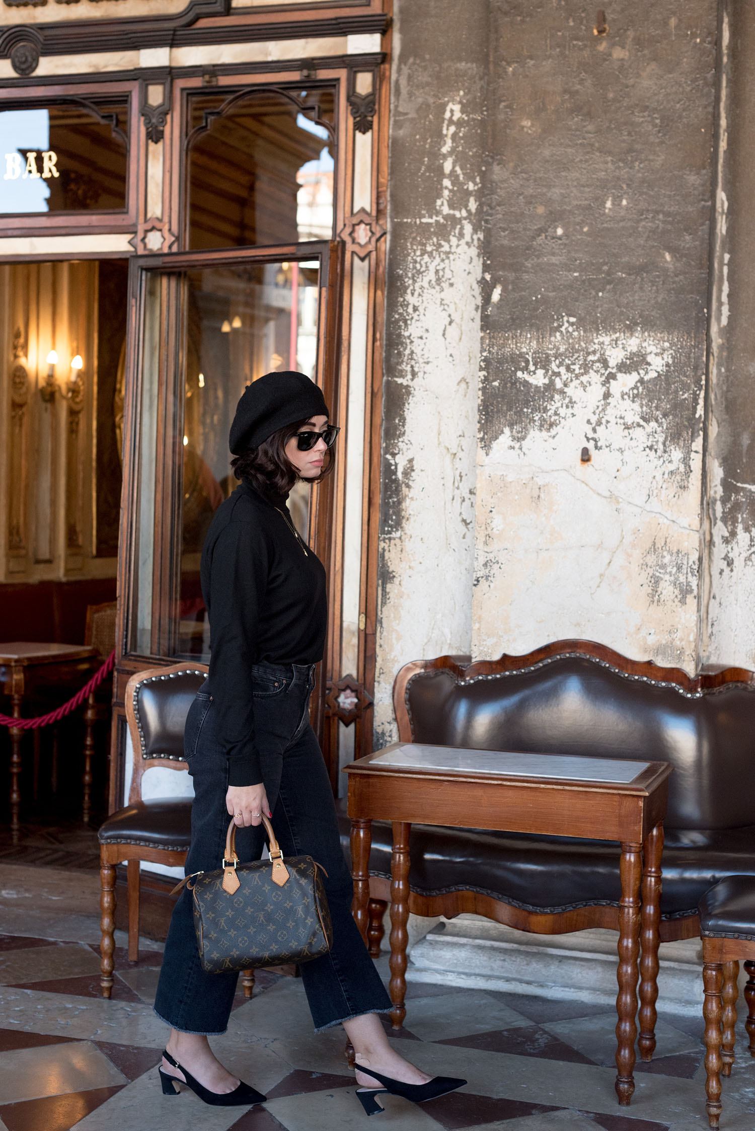 Top Canadian fashion blogger Cee Fardoe of Coco & Vera walks in Venice, Italy, wearing Mango kitten heels and carrying a Louis Vuitton Speedy 25 handbag
