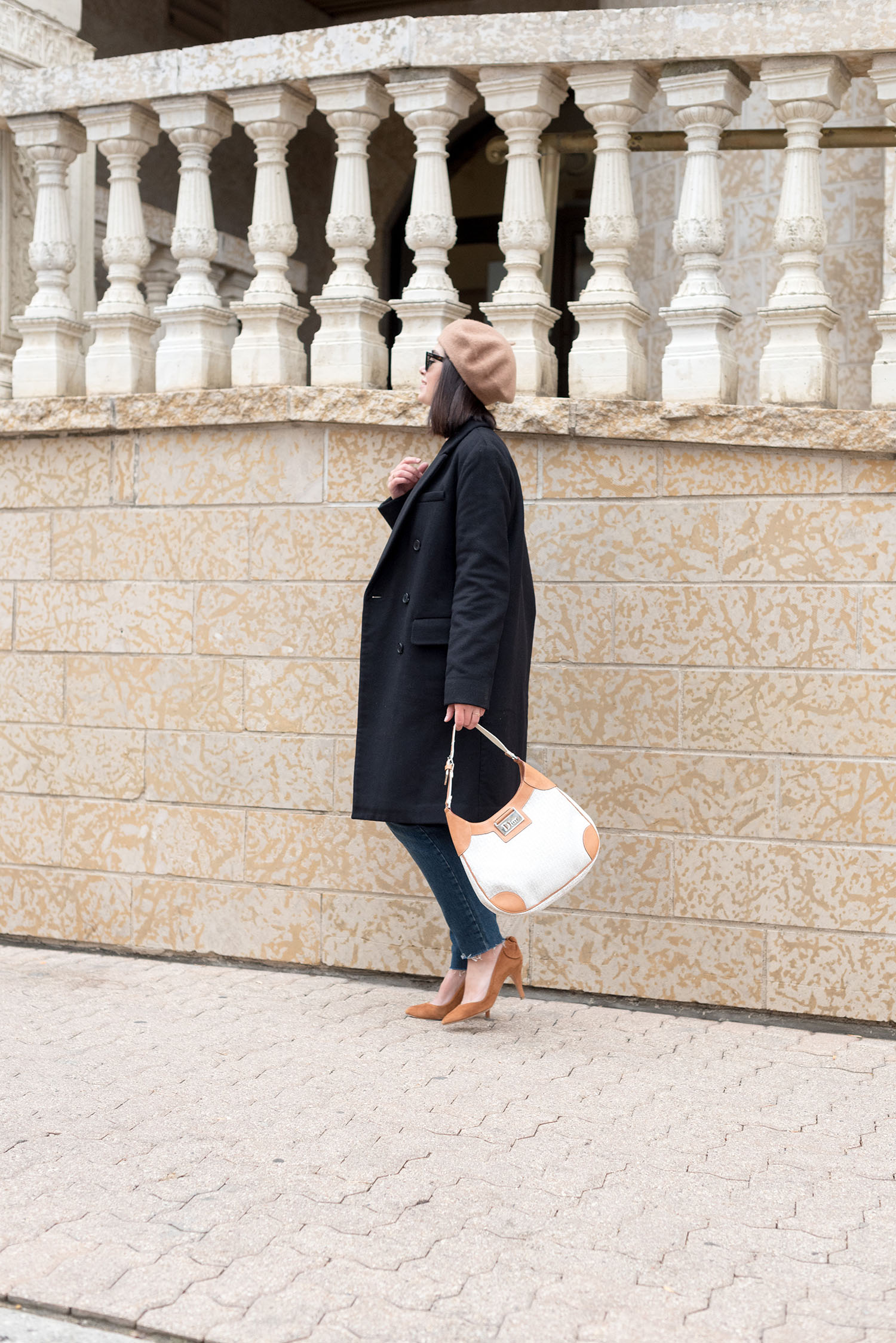 Top Winnipeg fashion blogger Cee Fardoe of Coco & Vera wears a black Aritzia coat and carries a vintage Dior handbag