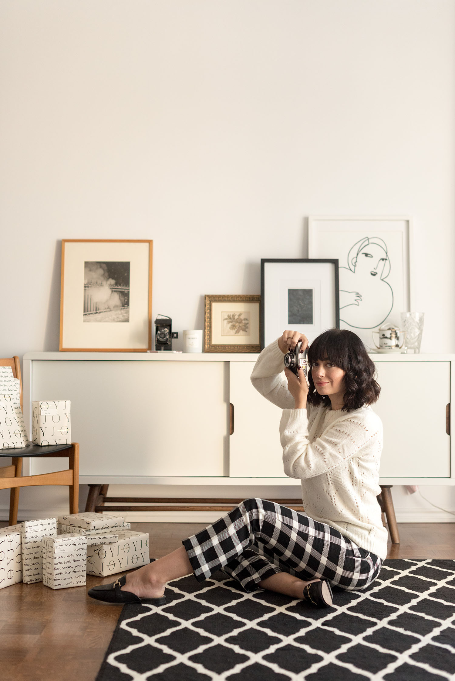 Top Winnipeg fashion blogger Cee Fardoe of Coco & Vera sits in her living room wear Gap cropped trousers and a white pointelle sweater