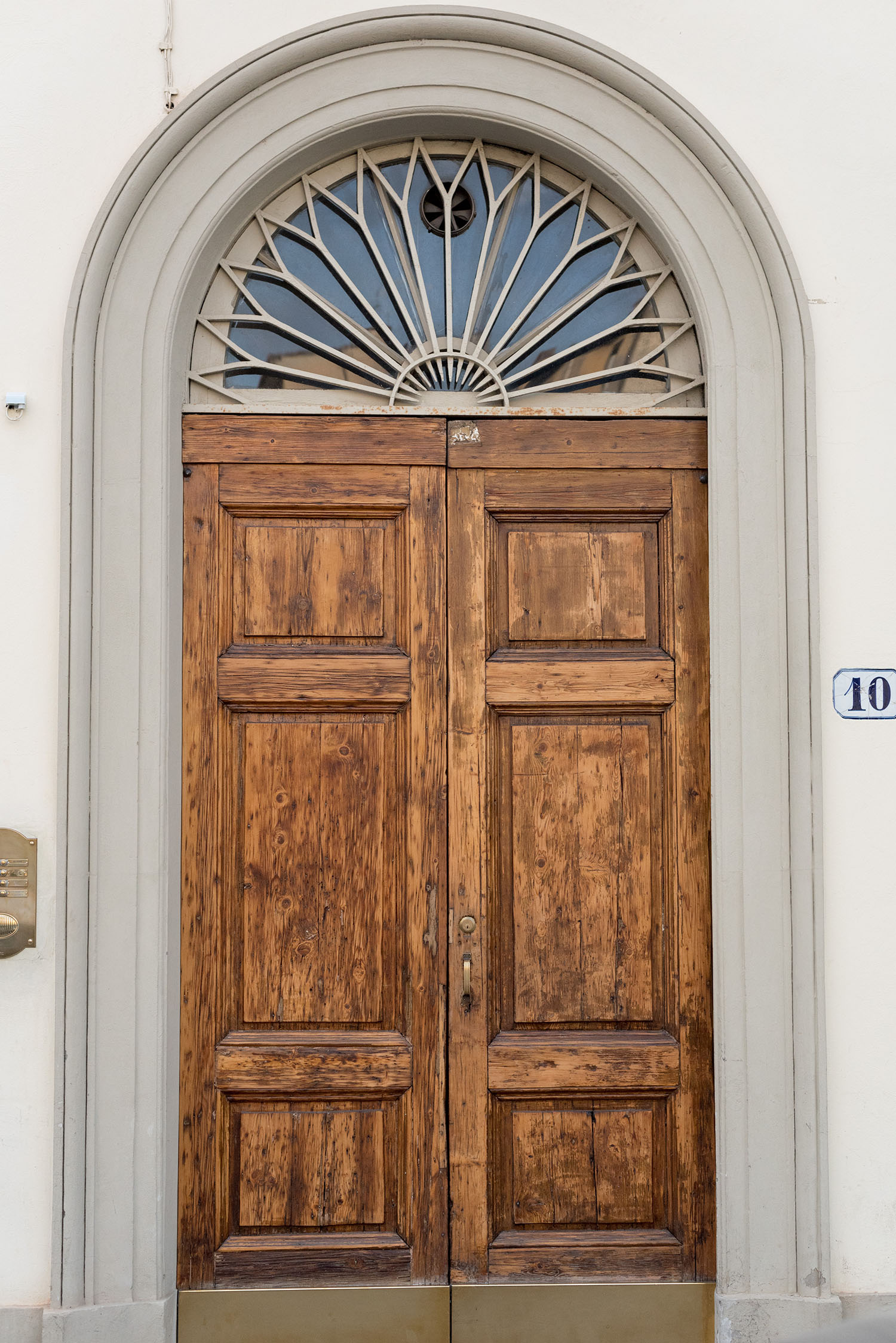 An old wooden door in Florence, Italy, as captured by top Canadian travel blogger Cee Fardoe of Coco & Vera