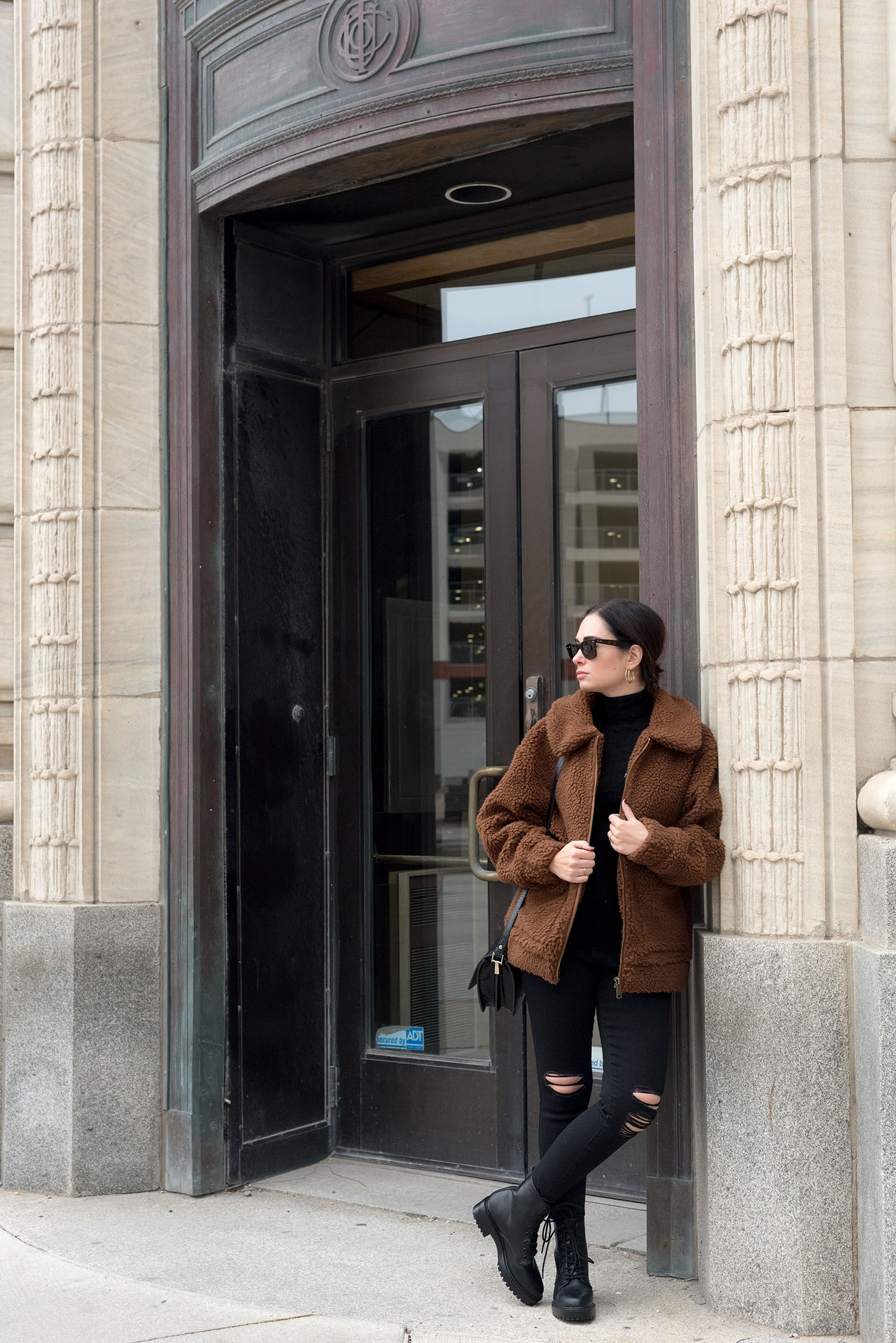 Top Canadian fashion blogger Cee Fardoe of Coco & Vera wears a Garage Clothing teddy coat and Old Navy jeans outside Birks in the Exchange District in Winnipeg