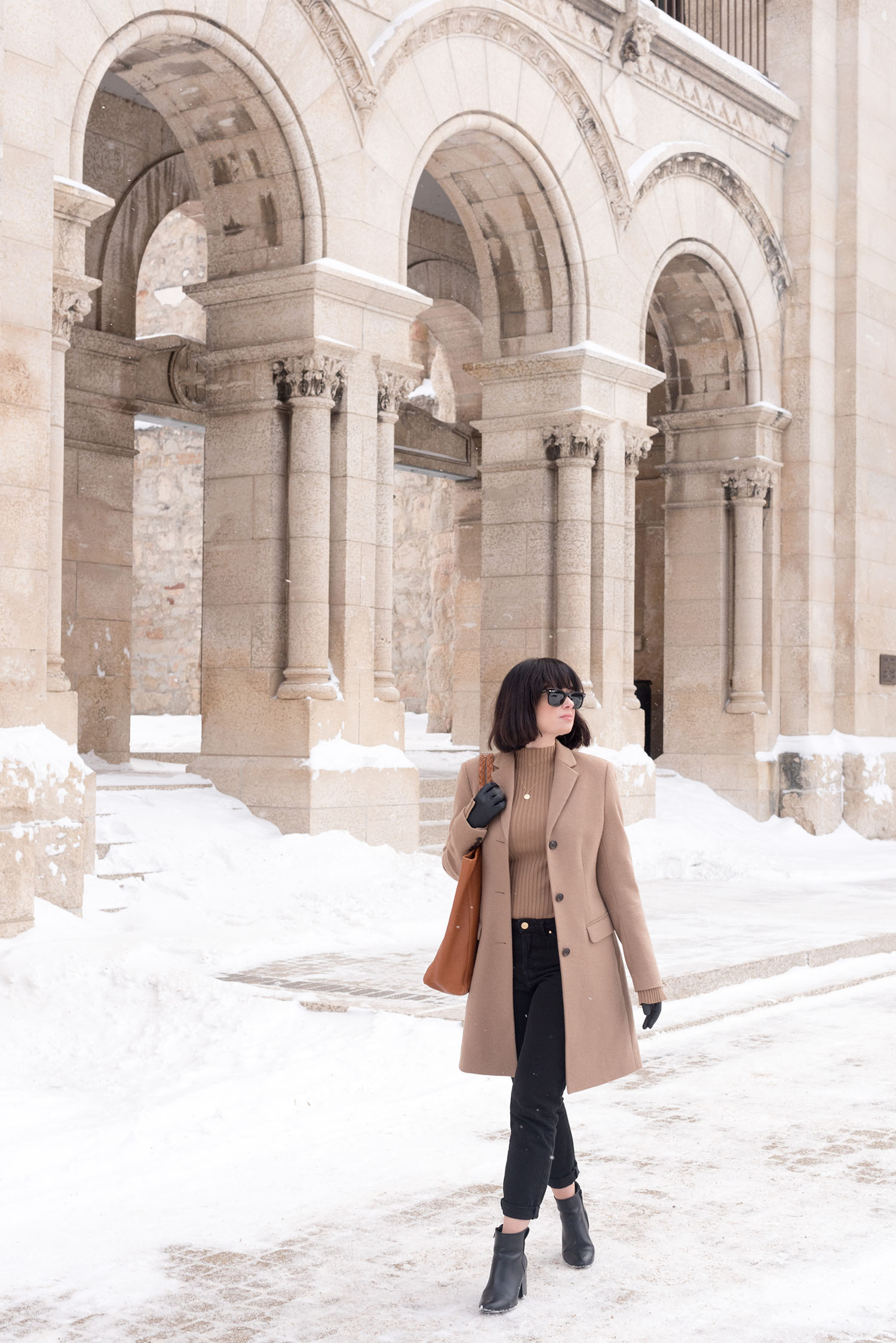 Top Winnipeg fashion blogger Cee Fardoe of Coco & Vera wears an Uniqlo camel coat and Sezane black jeans