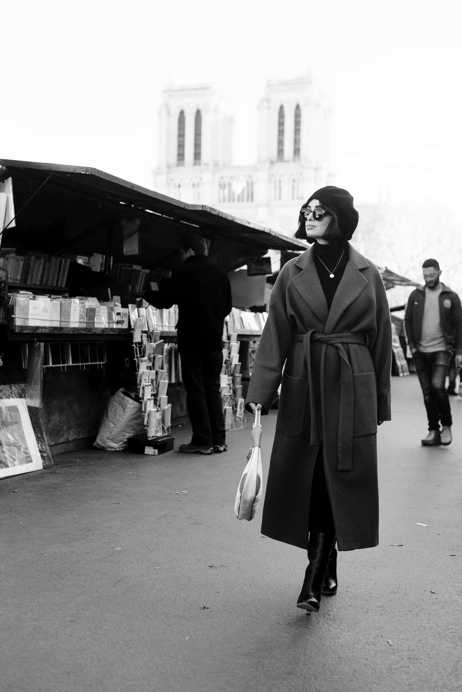 Top Canadian fashion blogger Cee Fardoe of Coco & Vera walks along the quais in Paris, wearing a Zara wrap coat and carrying a Dior handbag