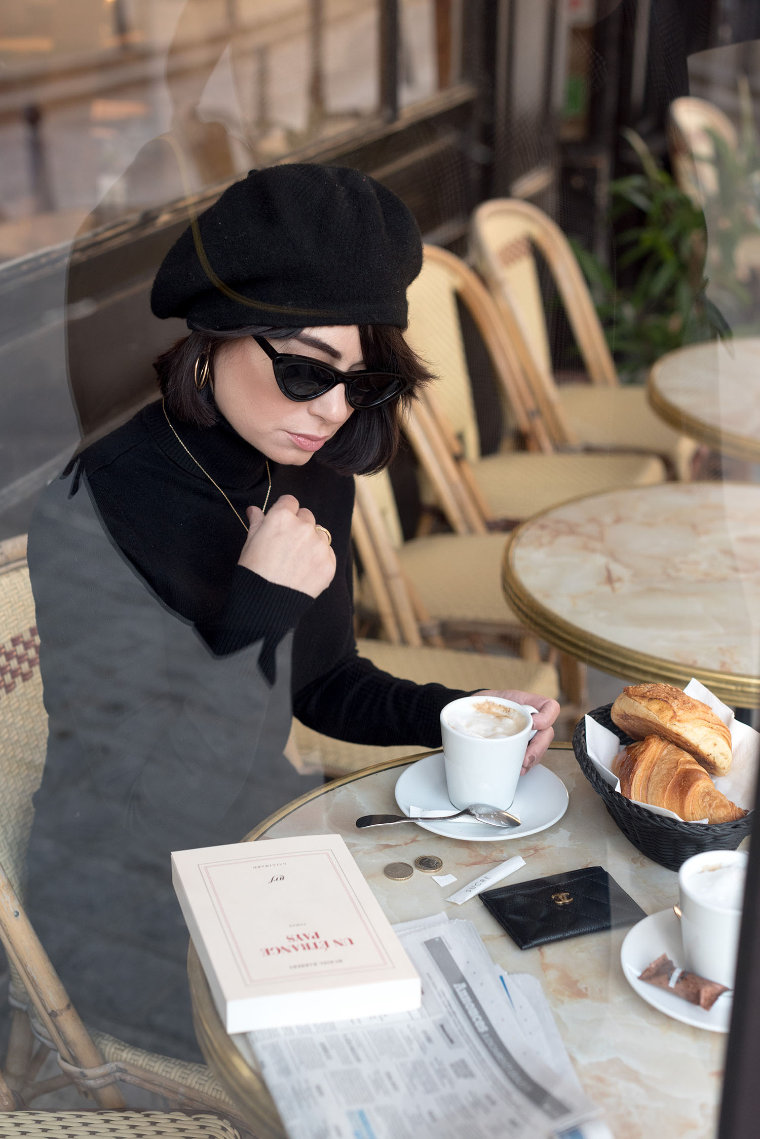 Portrait of top Canadian fashion blogger Cee Fardoe of Coco & Vera at a Parisian cafe, wearing and Anthropologie Bonnie beret and a Le Chateau turtleneck sweater