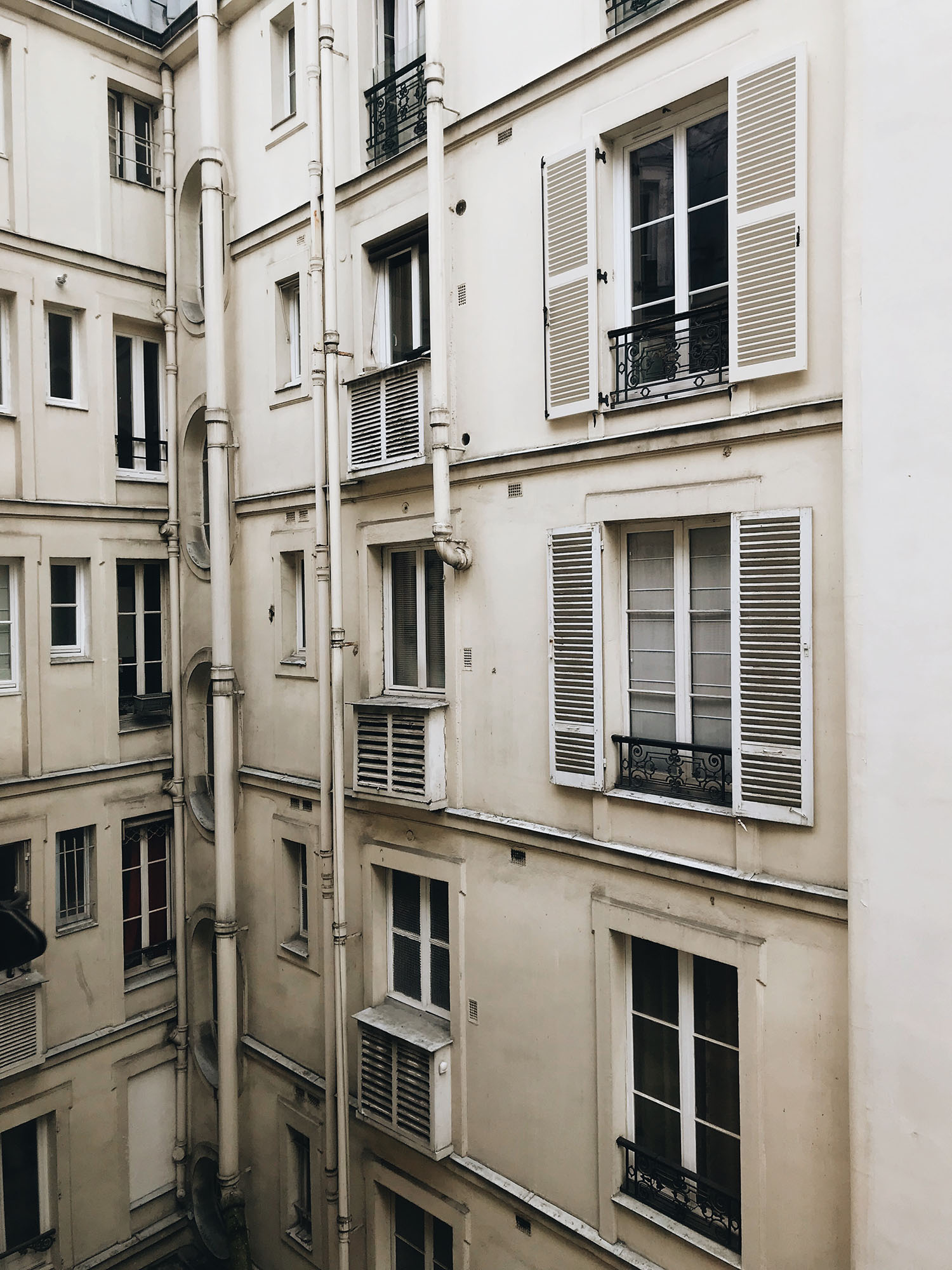 The interior courtyard of a Parisian apartment block, as captured by top Canadian travel blogger Cee Fardoe of Coco & Vera