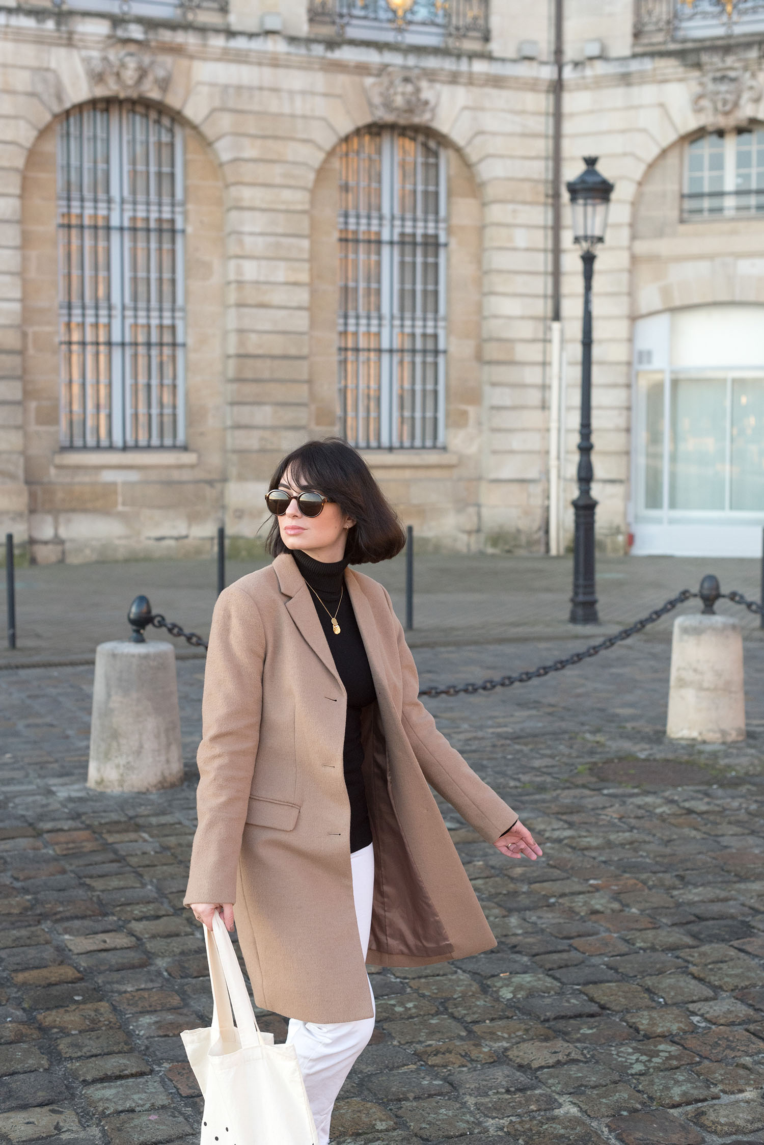 Portrait of top Canadian fashion blogger Cee Fardoe of Coco & Vera in Bordeaux, France, wearing & Other Stories sunglasses and a Uniqlo camel coat