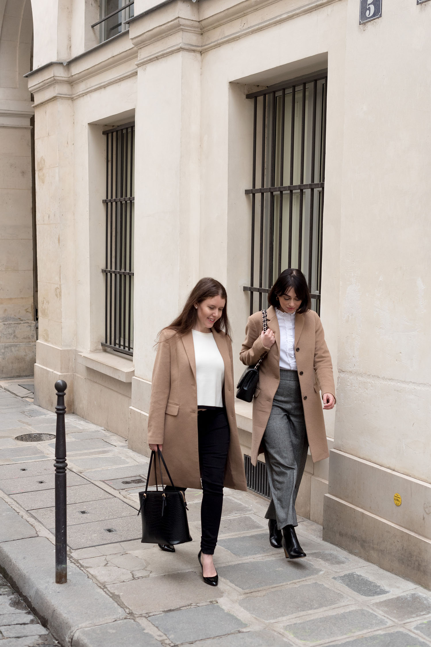 Top Canadian fashion bloggers Cee Fardoe of Coco & Vera and Lyndi Barrett of Style calling at the Palais-Royal in Paris, wearing Uniqlo camel coats