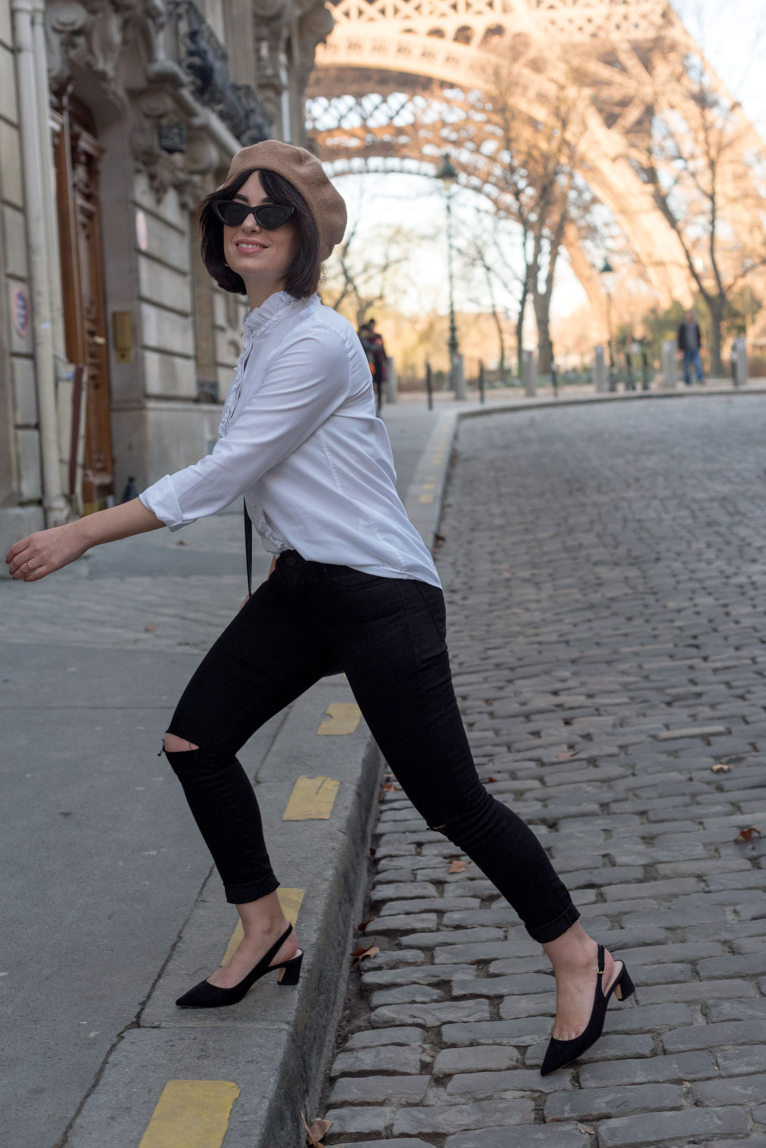 Top Canadian fashion blogger Cee Fardoe of Coco & Vera in Paris, wearing a white Sezane blouse and Mavi black jeans