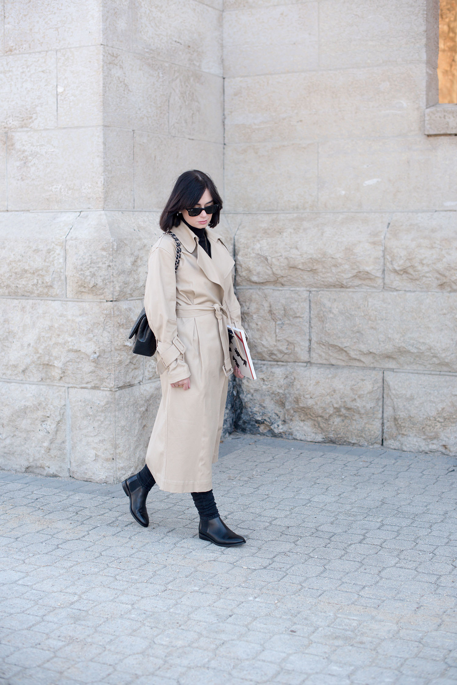 Top Winnipeg fashion blogger Cee Fardoe of Coco & Vera wears an H&M trench coat and Everyone Chelsea boots at St. Boniface Cathedral