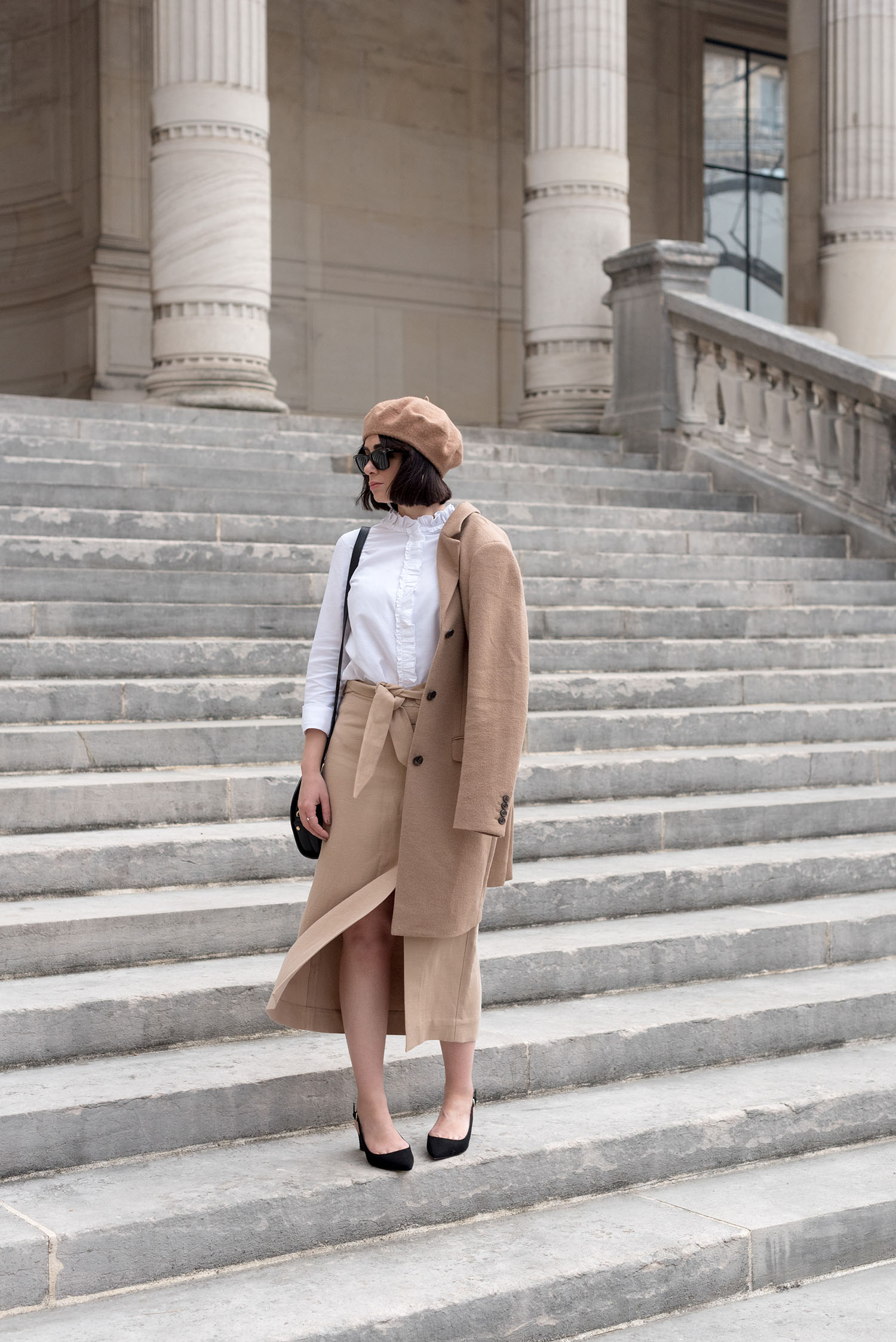 Top Canadian fashion blogger Cee Fardoe of Coco & Vera at Musee Galliera in Paris, wearing a Uniqlo camel coat and & Other stories midi skirt