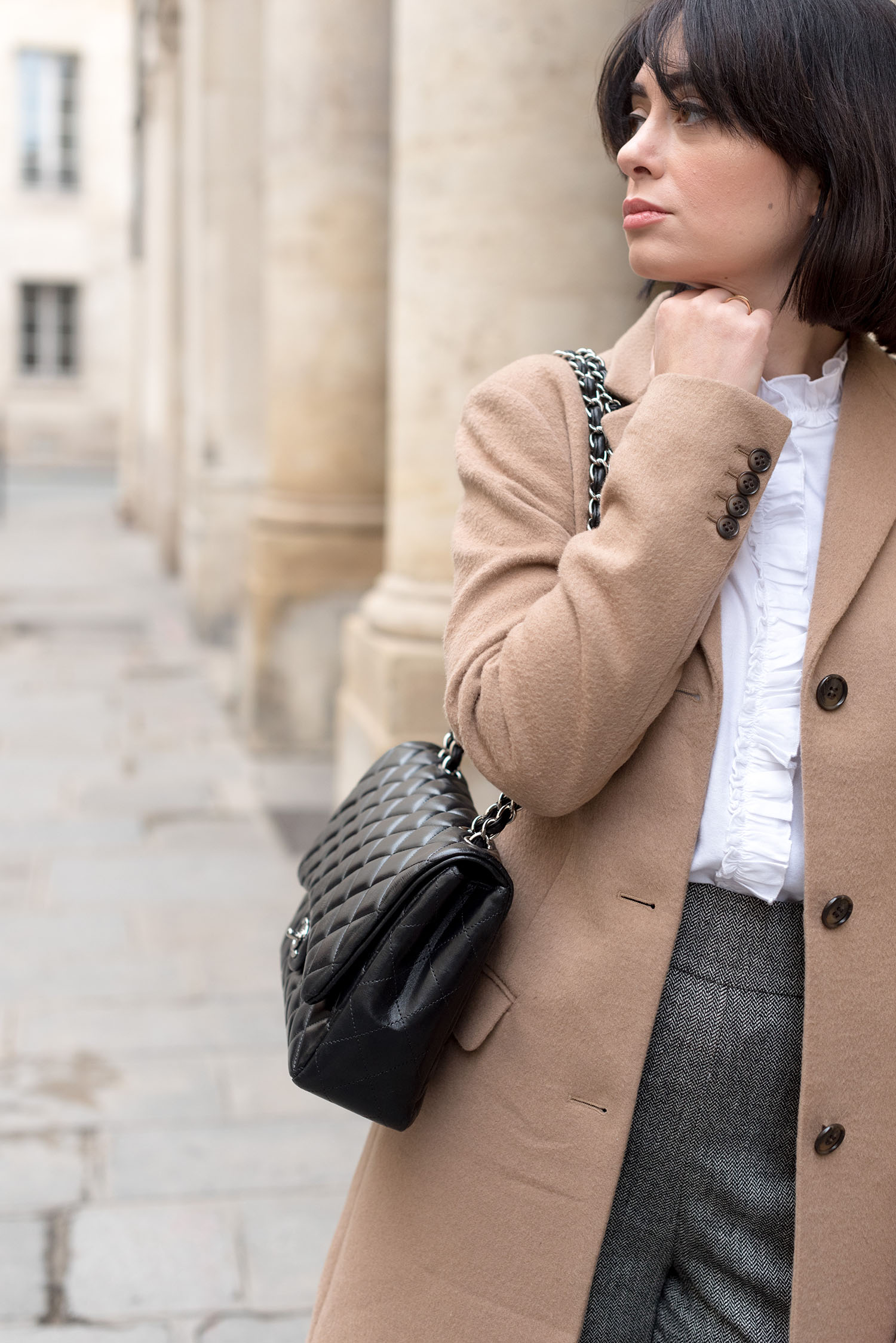 Portrait of top Winnipeg fashion blogger Cee Fardoe of Coco & Vera at the Palais Royal in Paris, wearing a Sezane blouse and carrying a Chanel single flap handbag