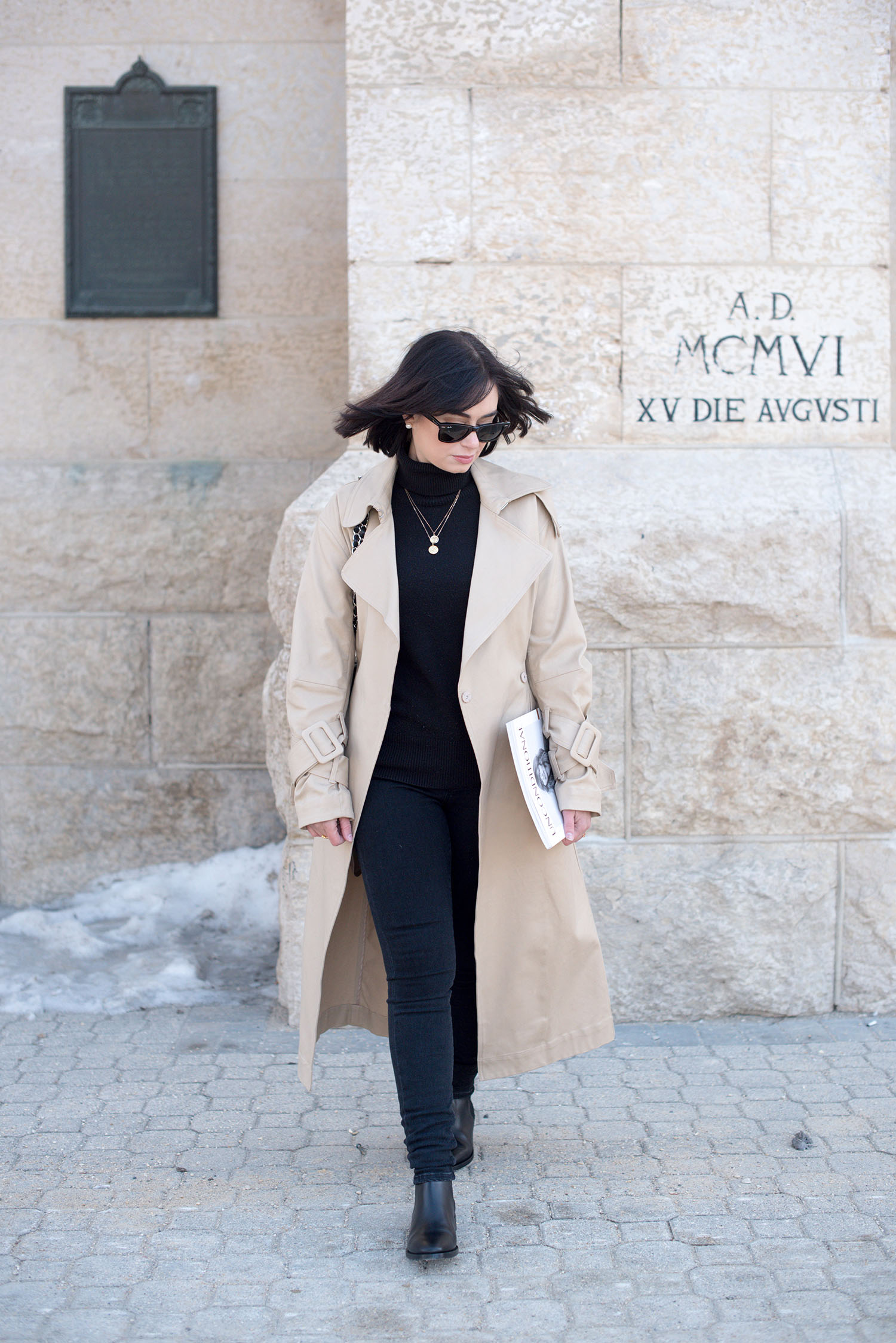 Top Canadian style blogger Cee Fardoe of Coco & Vera wears an H&M trench coat and Mavi skinny jeans at St. Boniface Cathedral in Winnipeg