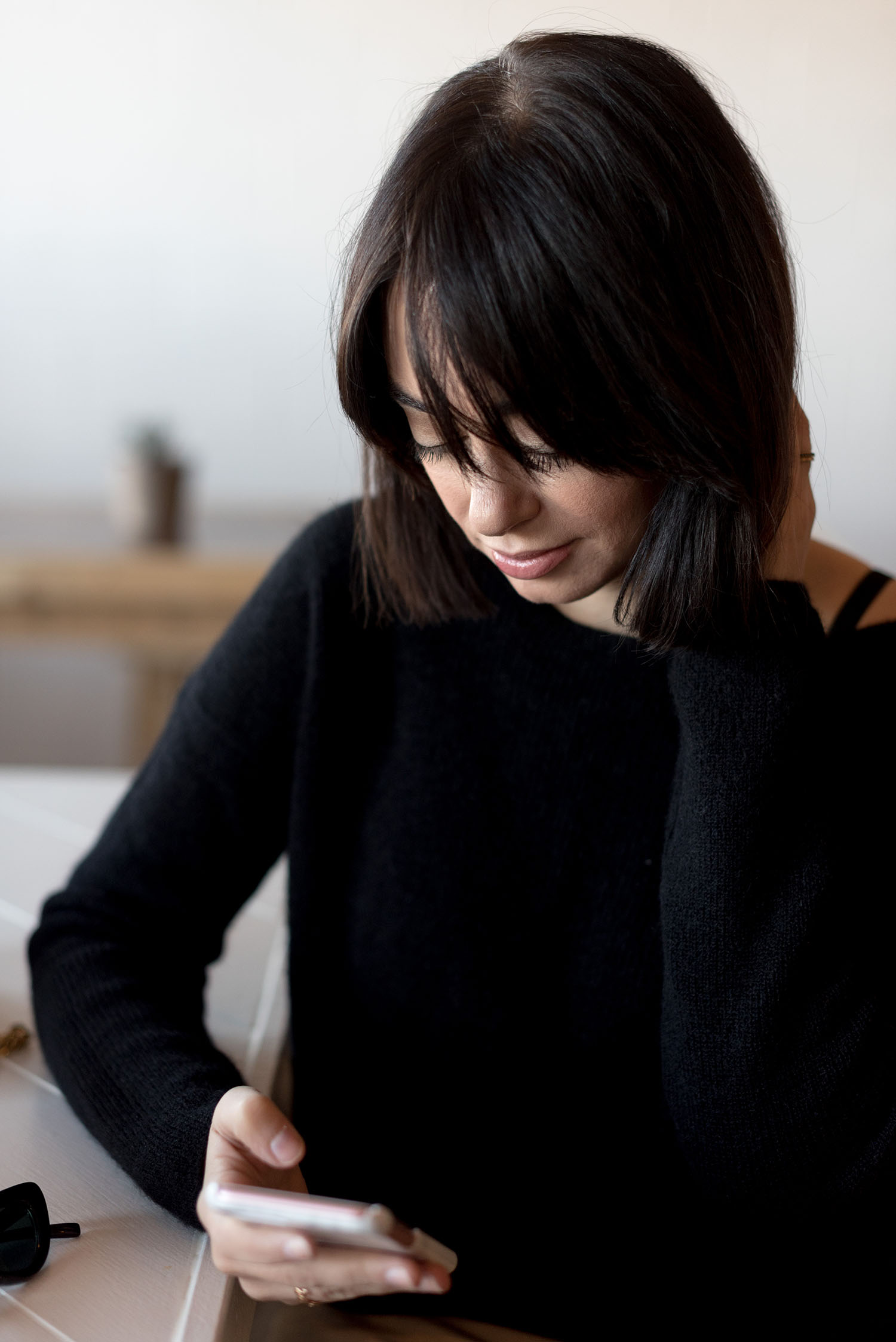 Portrait of top Canadian fashion blogger Cee Fardoe of Coco & Vera, wearing a black Sezane Barry sweater