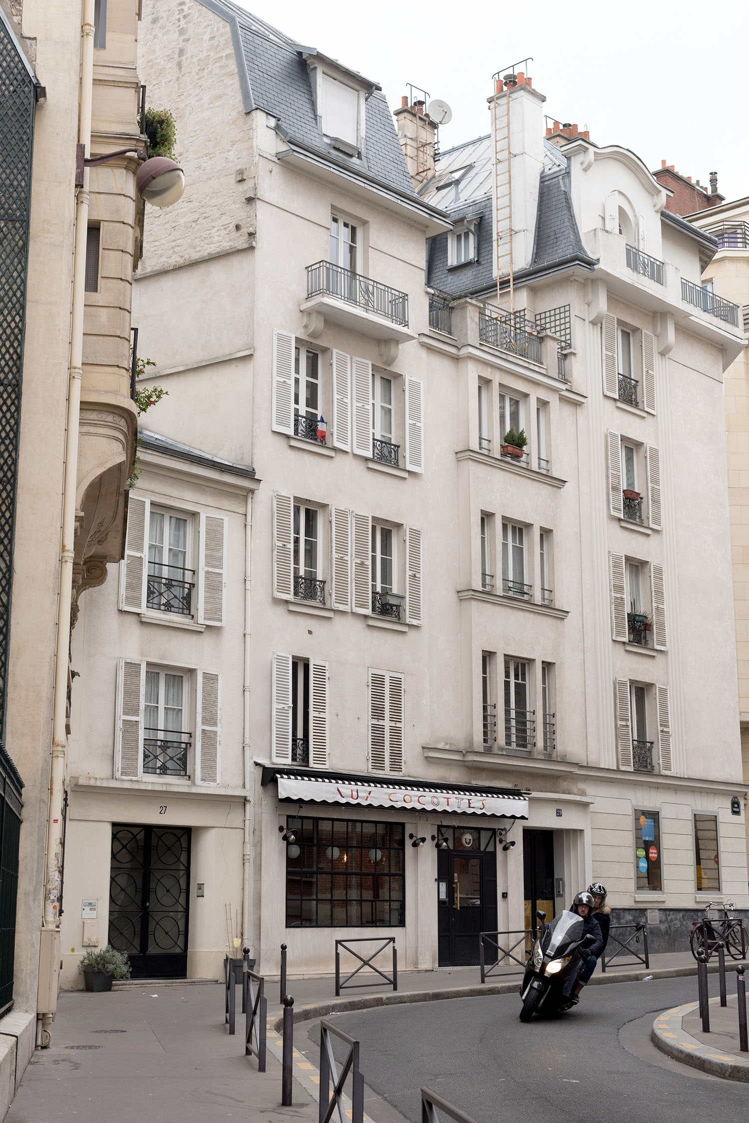 White buildings on a curved street in Paris, as captured by top Winnipeg travel blogger Cee Fardoe of Coco & Vera