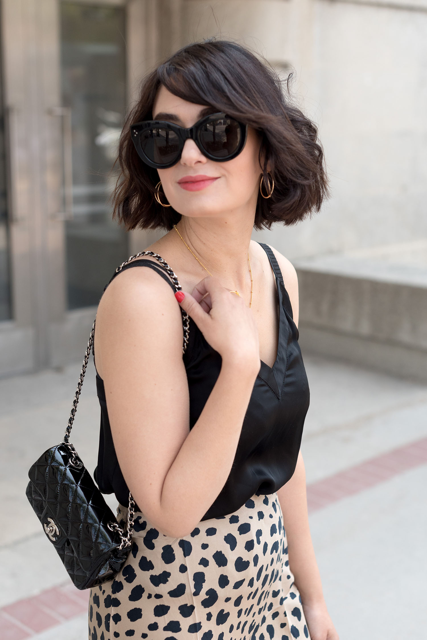 Portrait of top Winnipeg fashion blogger Cee Fardoe of Coco & Vera, wearing Celine Audrey sunglasses and an Aritzia silk tank top