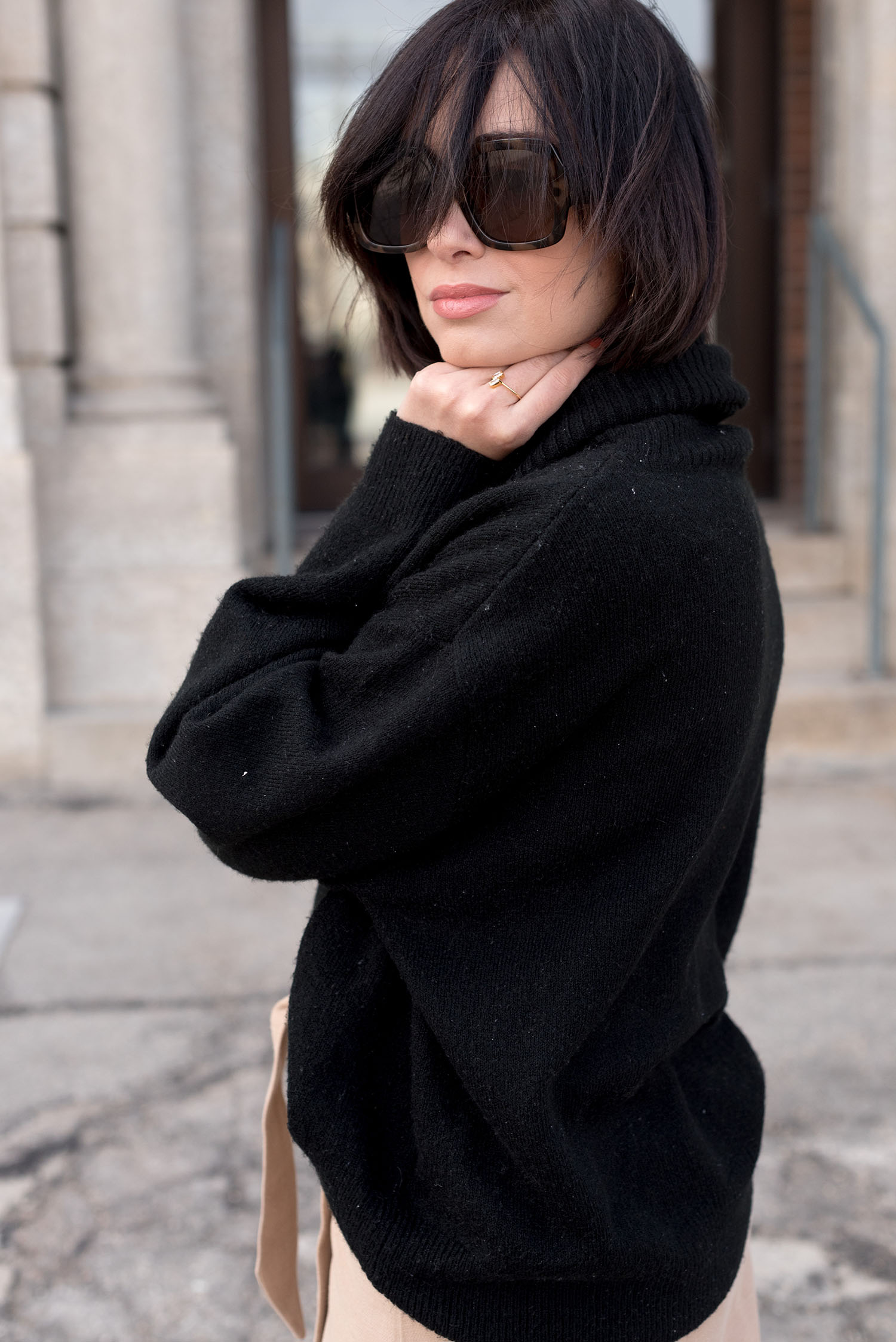 Portrait of top Winnipeg fashion blogger Cee Fardoe of Coco & Vera, wearing Mango sunglasses and an H&M black sweater