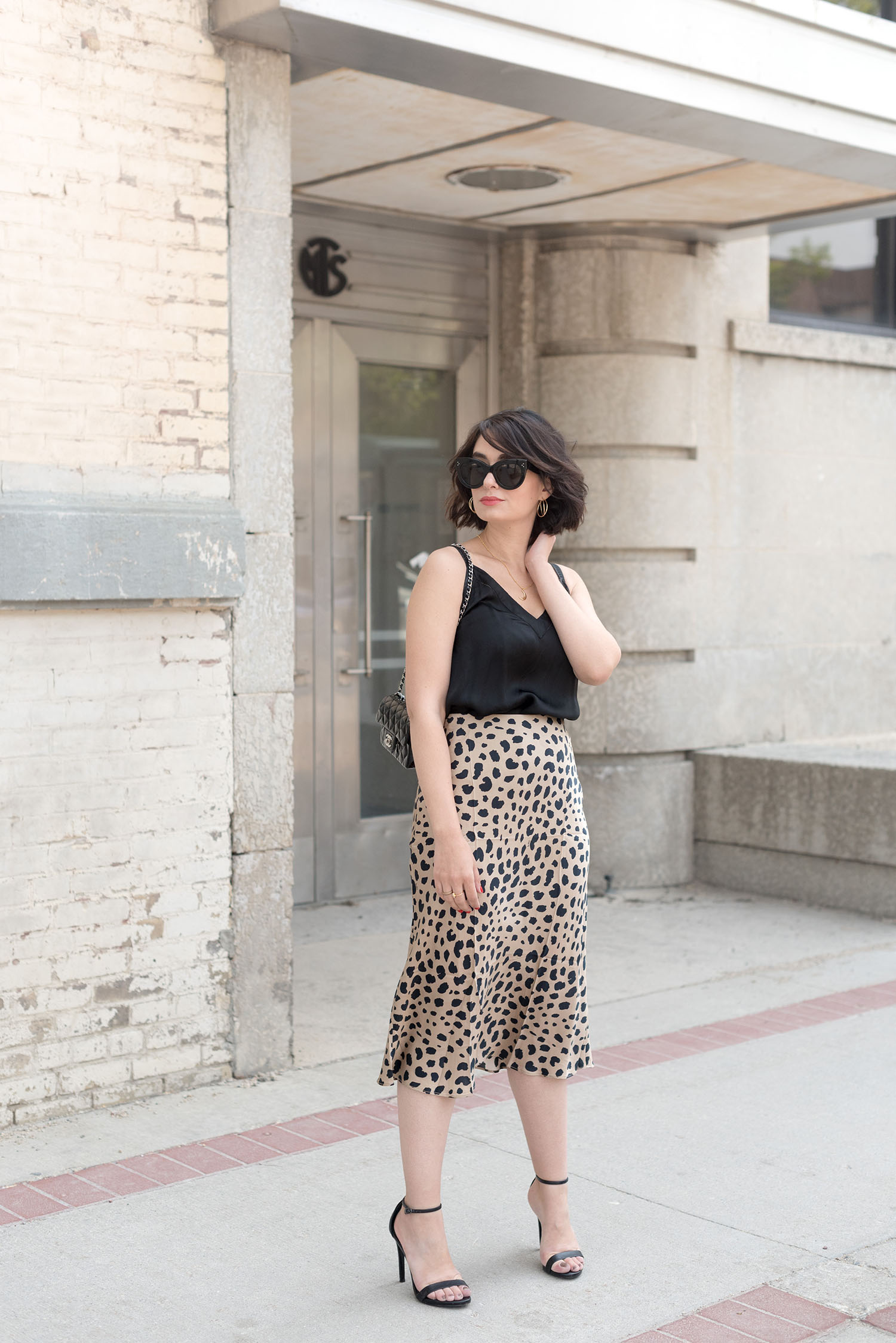 Top Winnipeg fashion blogger Cee Fardoe of Coco & Vera wears an Aritzia silk tank and Realisation Par Naomi leopard print skirt