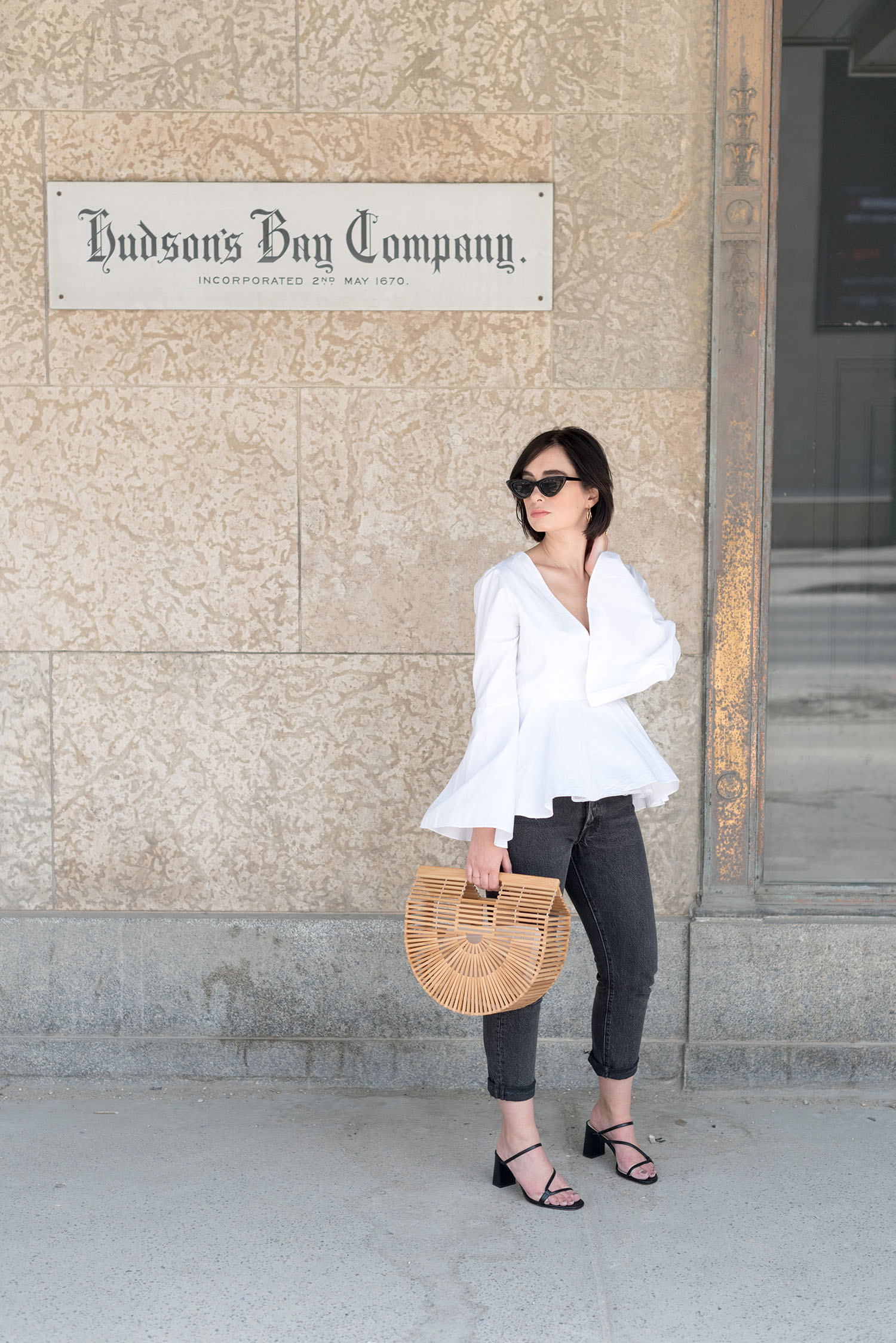 Top Winnipeg fashion blogger Cee Fardoe of Coco & Vera at the Bay Downtown wearing a white L'academia blouse and Levi's 501 skinny jeans