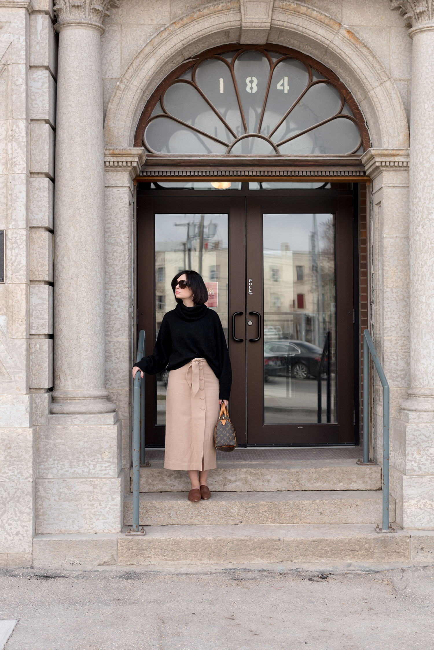 Top Winnipeg fashion blogger Cee Fardoe of Coco & Vera waits for summer at Oseredok, wearing an H&M sweater and & Other Stories midi skirt
